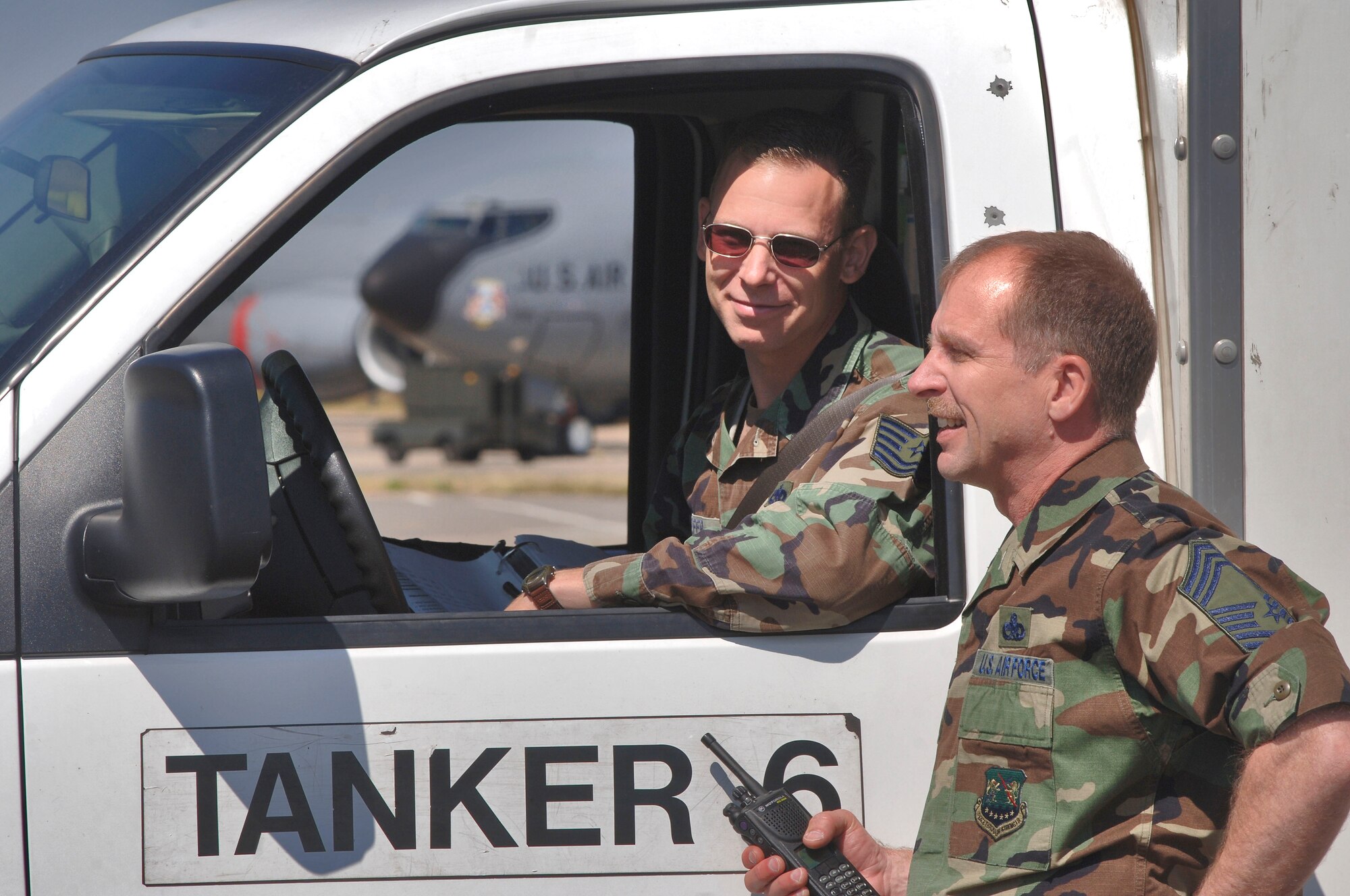 Chief Master Sgt. Brian Allison (right) and Tech. Sgt. Edward Pfeifer discuss maintenance for a KC-135 Stratotanker at Royal Air Force Mildenhall on July 24.  Chief Allison is the 100th Maintenance Group superintendent and Sergeant Pfeifer is a group expediter. The group has 14 Airmen on each 12-hour shift to keep the 100th Air Refueling Wing's 15 tankers, all nearly 50 year old, ready to fly. (U.S. Air Force photo/Master Sgt. Lance Cheung)
