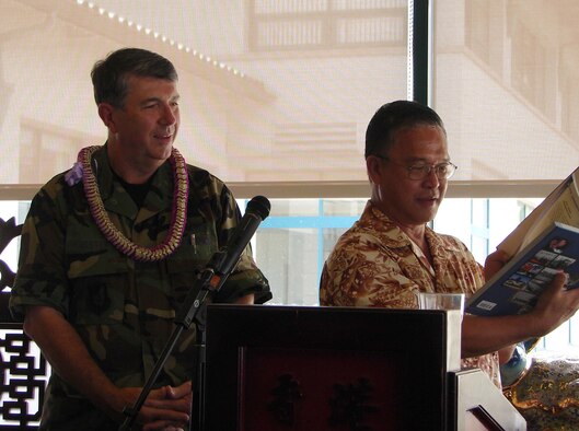 HICKAM AIR FORCE BASE, Hawaii -- General Paul V. Hester, commander, Pacific Air Forces receives a commemorative book from Don Ho, Chinese Chamber of Commerce.  The book details the history of the famed “Flying Tigers” and 14th Air Force under the command of Maj. Gen. Claire Chennault and is signed by a Chinese ground crew member living in China.  The General spoke to the Chinese Chamber of Commerce of Hawaii Thursday regarding the importance of diplomatic relationships in the Pacific and with China in particular.  (Air Force photo by Capt Allison Farabaugh)