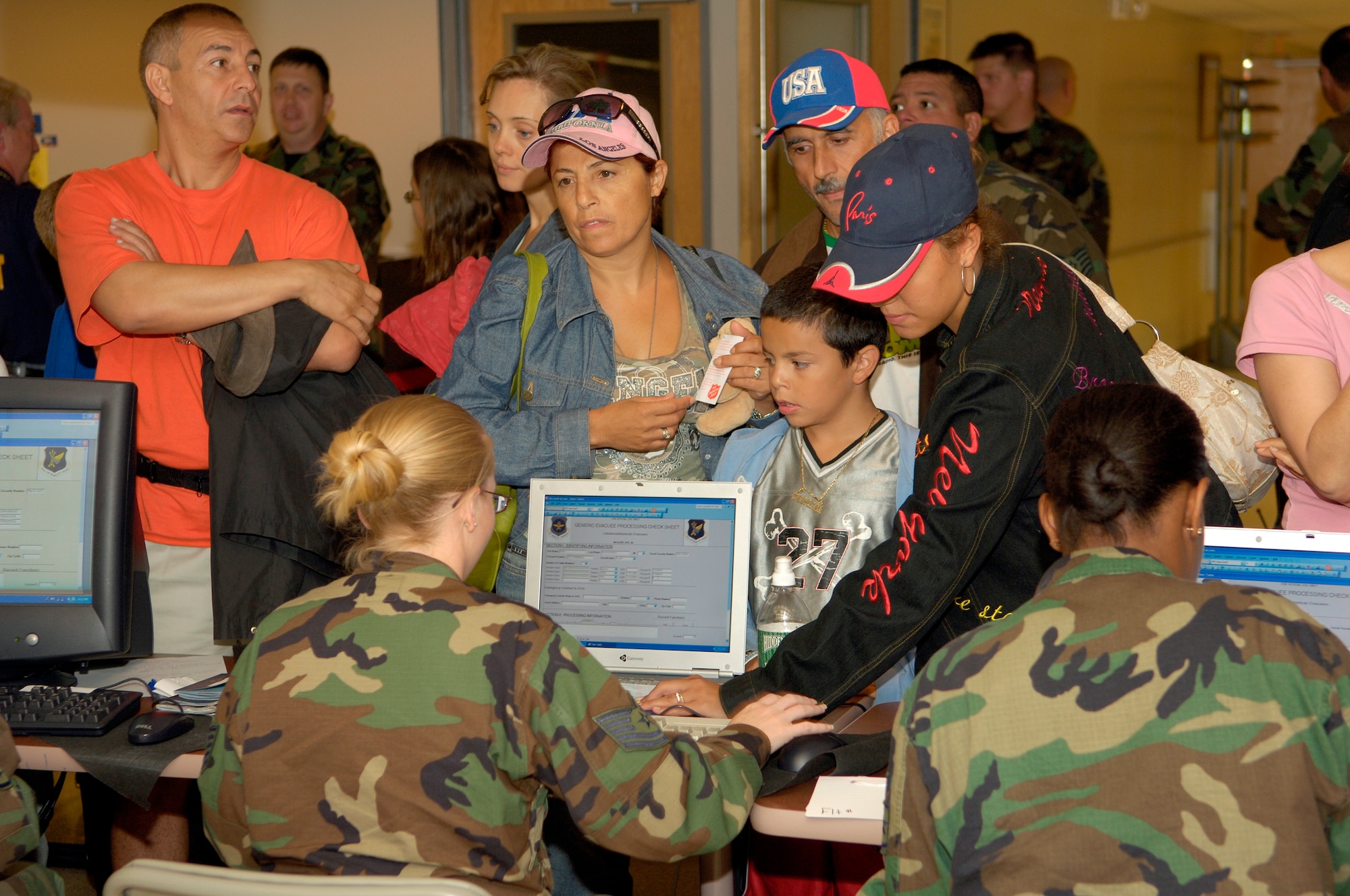 Airmen from McGuire Air Force Base, N.J. assist arrivals with inprocessing as part of Department of State efforts to evacuate U.S. citizens from Lebanon because of the fighting there. The United States is using all available means to ensure safe passage of American citizens out of Lebanon, including chartered commercial ships, US military aircraft, and US military ships en route to the Eastern Mediterranean. (U.S. Air Force Photo by Kenn Mann)