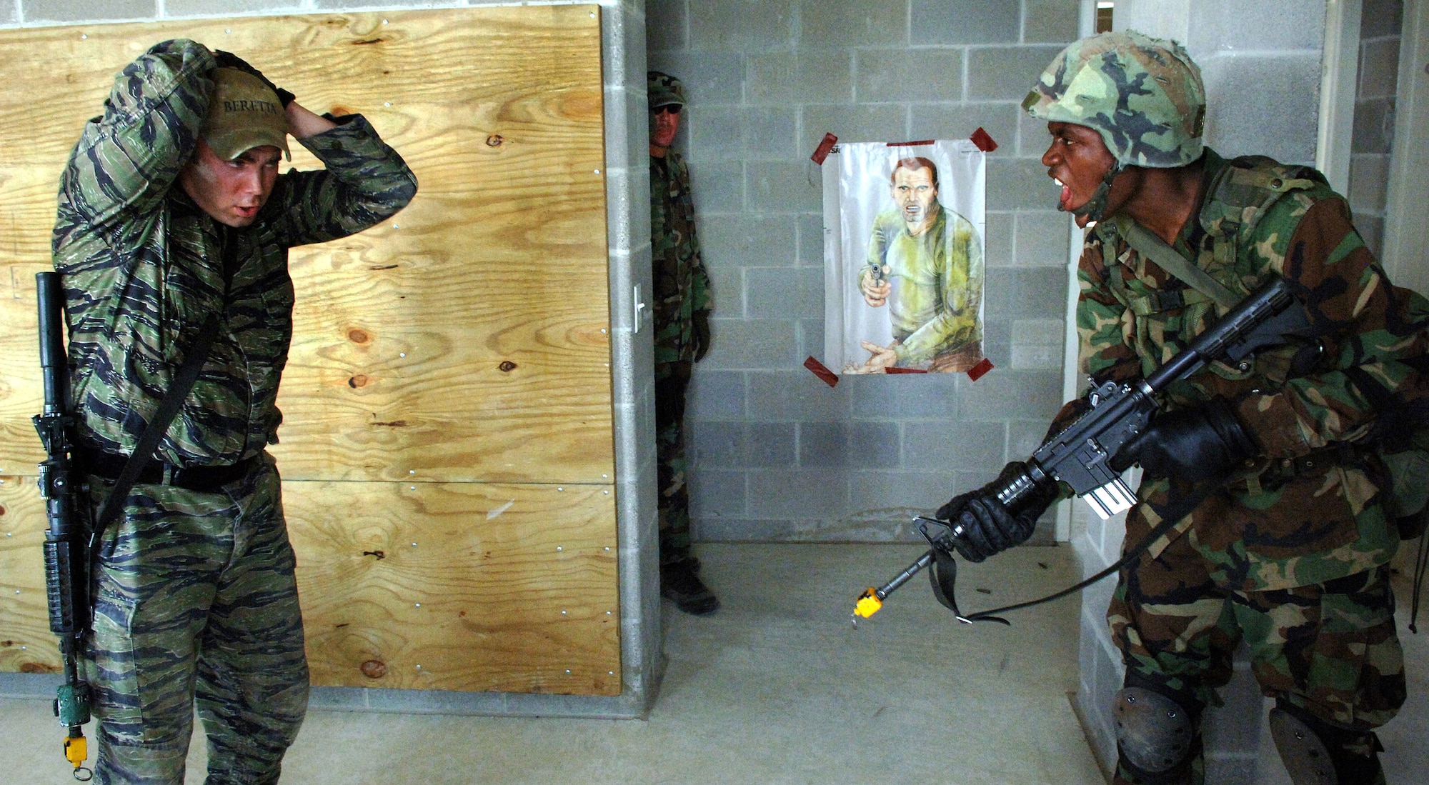 Airman Stephen Brown, right, shouts instructions to Staff Sgt. Travis Crawley who is playing the role of a terrorist during the Security Forces Academy training at Camp Bullis, Texas, on Wednesday, July 19. The 343rd Training Squadron instructs Airmen on air base defense and combat operations. Sergeant Crawley is an instructor for the 343rd TRS. (U.S. Air Force photo/Tech. Sgt. Larry A. Simmons)