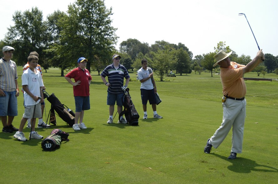 Patrick Keefe, Eagle Creek Golf Course assitant golf professional, shows a group of children how to properly hit an iron, emphazing grip on the club and aiming at the target. The children are participating in the Ladies Professional Golf Association Urban Youth Golf Program where they learn from LPGA instructors and Dover members. (U.S. Air Force photo/Airman 1st Class James Bolinger)