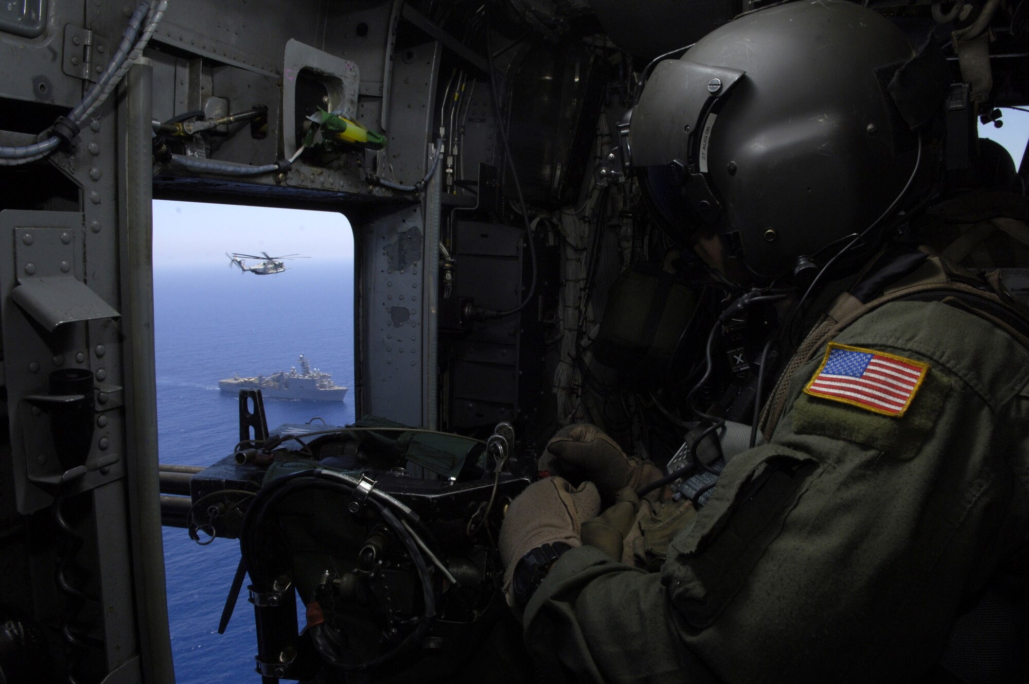 Tech. Sgt. John Stott looks out the left side of his MH-53M Pave Low helicopter as it escorts a Marine CH-53 Sea Stallion transporting Secretary of State Condoleezza Rice from Cyprus to the U.S. Embassy in Beirut, Lebanon, July 24.  Sergeant Stott is part of the 352nd Special Operations Group, Royal Air Force Mildenhall, deployed to Cyprus to help transport Americans who are voluntarily departing Lebanon.  (U.S. Air Force photo/Senior Airman Brian Ferguson) 