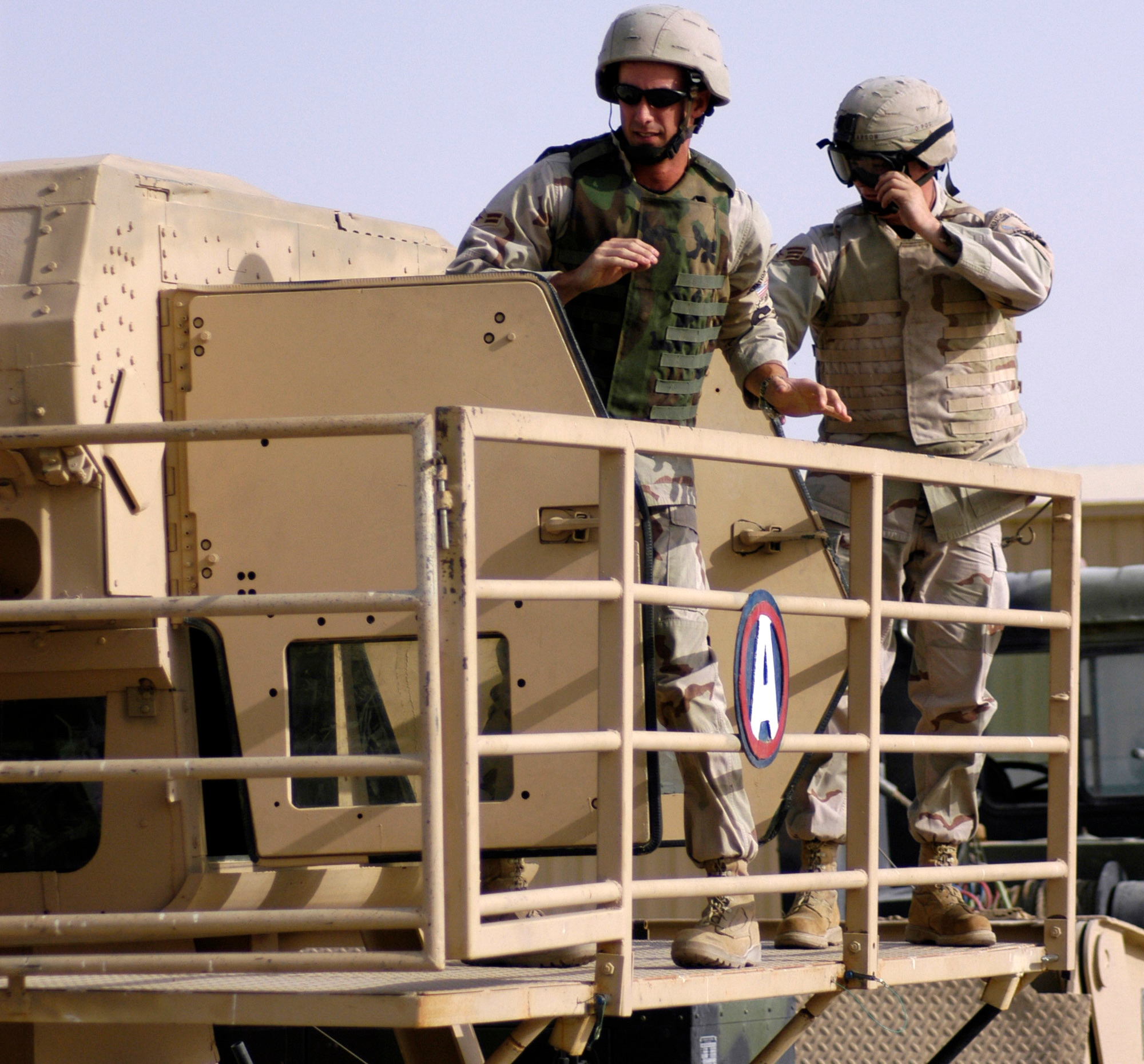 Airman 1st Class Jason Tinnin and Senior Airman Shane Larson exit the Humvee egress assistance trainer on July 17 at a forward operating base in Southwest Asia. The trainer aids military members with instruction on how to escape from a Humvee that has rolled over and how to avoid such accidents. Airman Tinnin is deployed from Scott Air Force Base, Ill., and Airman Larson is deployed from Grand Forks Air Force Base, N.D. Both are assigned to the 386th Expeditionary Security Forces Squadron. (Air Force photo by Staff Sgt. Ryan Hansen)