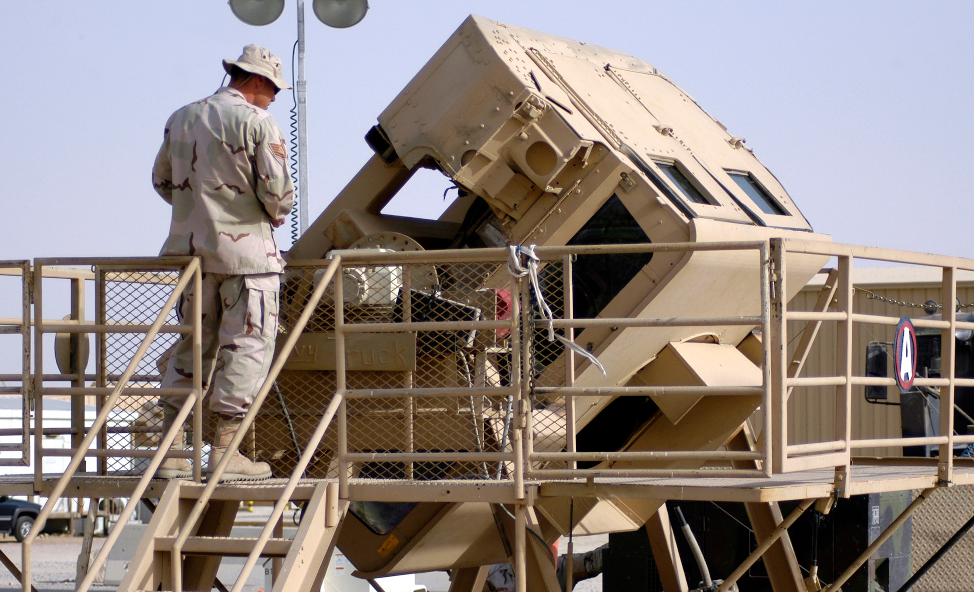 Tech. Sgt. Jeffry Prough operates the Humvee egress assistance trainer on July 17 at a forward operating base in Southwest Asia. The trainer aids military members with instruction on how to escape from a Humvee that has rolled over and how to avoid such accidents. Sergeant Prough is assigned to the 386th Expeditionary Security Forces Squadron. (U.S. Air Force photo/Staff Sgt. Ryan Hansen)