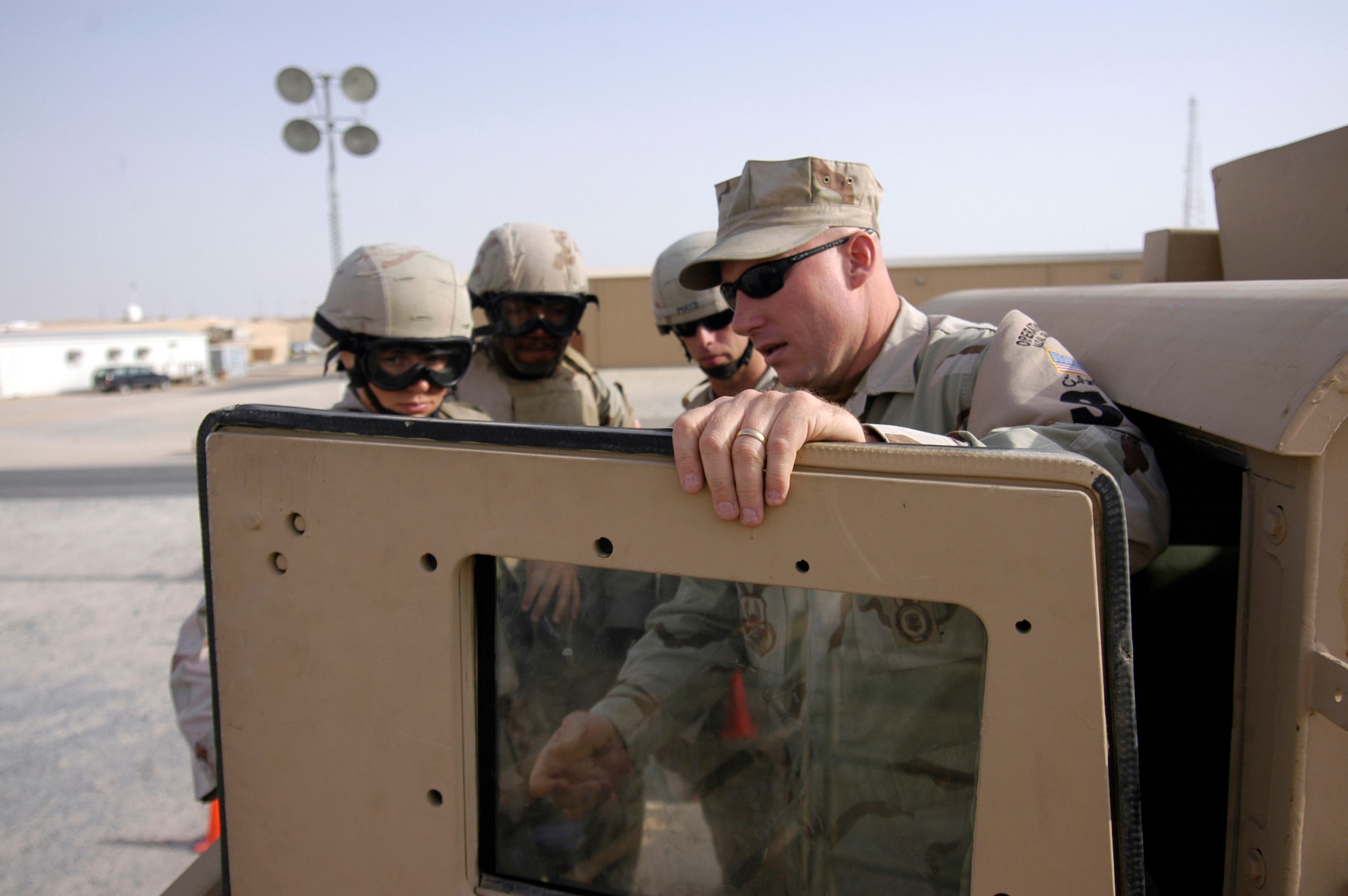 Master Sgt. John Ward instructs Airmen before they enter the Humvee egress assistance trainer July 17 at a forward operating base in Southwest Asia. The trainer aids military members with instruction on how to escape from a Humvee that has rolled over and how to avoid such accidents. Sergeant Ward is the NCO in charge of training for the 386th Expeditionary Security Forces Squadron. (U.S. Air Force photo/Staff Sgt. Ryan Hansen)
