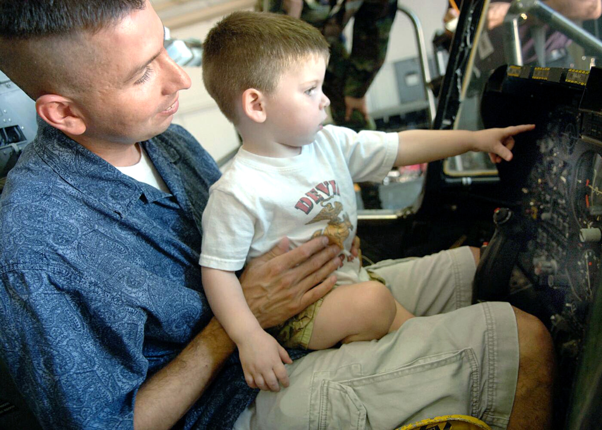 Mark Holguin holds his son, Jacob, 2, as they sit in the cockpit of an A-10 Thunderbolt II during a tour of Davis-Monthan Air Force Base, Ariz., on July 17. The Make-A-Wish Foundation teamed with Davis-Monthan to offer a tour of the base for Jacob and other Make-A-Wish children as well as their families. The tour consisted of demonstrations by an explosive ordnance disposal robot, base fire department and a weapons load crew for an A-10. (U.S. Air Force photo/Senior Airman Christina D. Ponte)