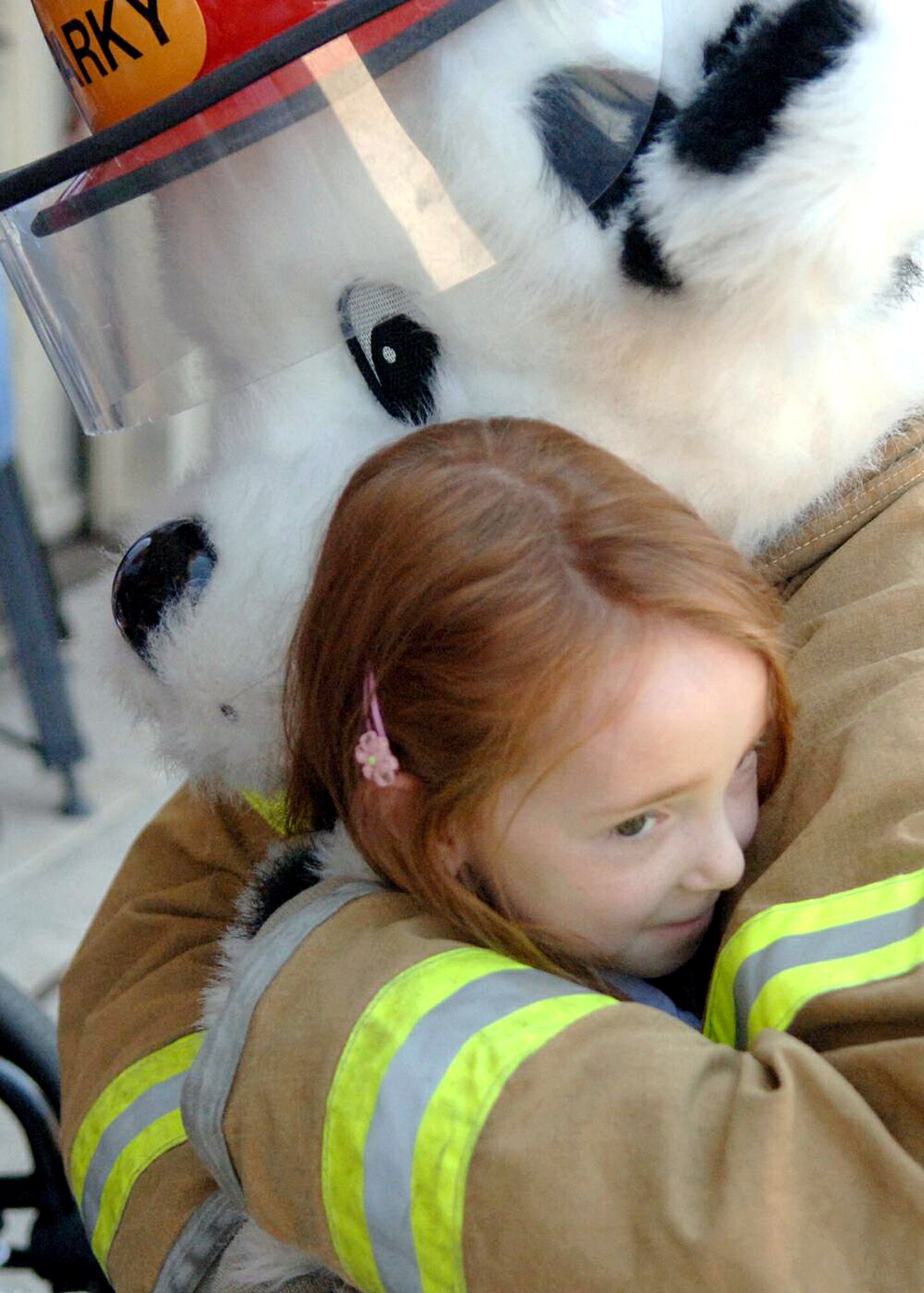 Hannah Mockbee hugs Sparky the fire safety dog during a tour of Davis-Monthan Air Force Base, Ariz., on July 17. The Make-A-Wish Foundation teamed with Davis-Monthan to offer a tour of the base for Hannah and other Make-A-Wish children as well as their families. The tour consisted of demonstrations by an explosive ordnance disposal robot, base fire department and a weapons load crew for an A-10 Thunderbolt II. Hannah is the daughter of Jeff and Stacie Mockbee. (U.S. Air Force photo/Senior Airman Christina D. Ponte)