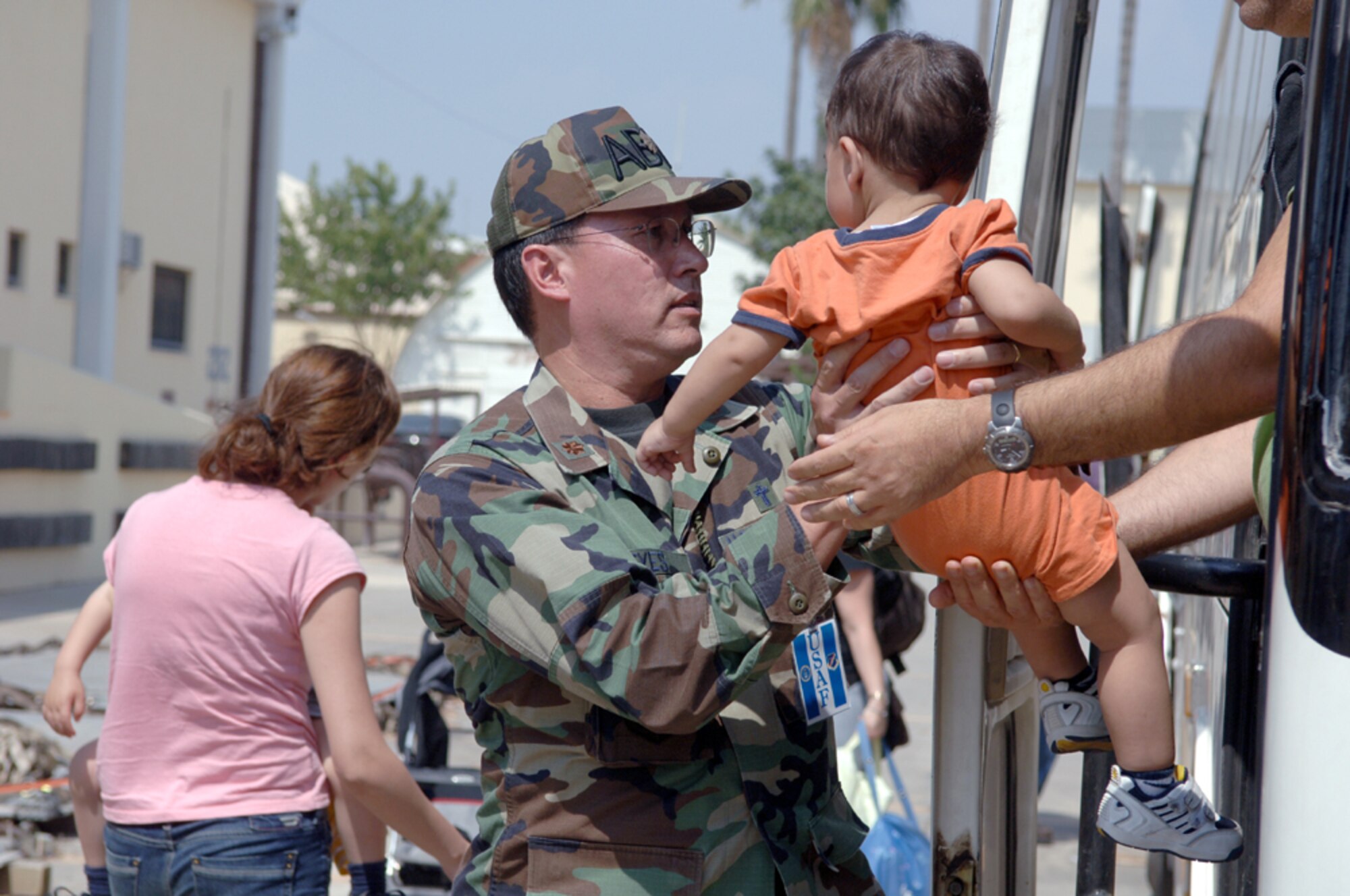 7/24/2006 - INCIRLIK AIR BASE, TURKEY -- U.S Air Force Major (Chaplain) Kenneth Reyes, 39th Air Base Wing Chaplain, holds a toddler, who is one of many American citizens who departed Lebanon and arrived here at the 39th Logistics Readiness Squadron's Deployment Processing Center.
(U.S Air Force Photo by Senior Airman Larry E. Reid Jr.)
(Released)