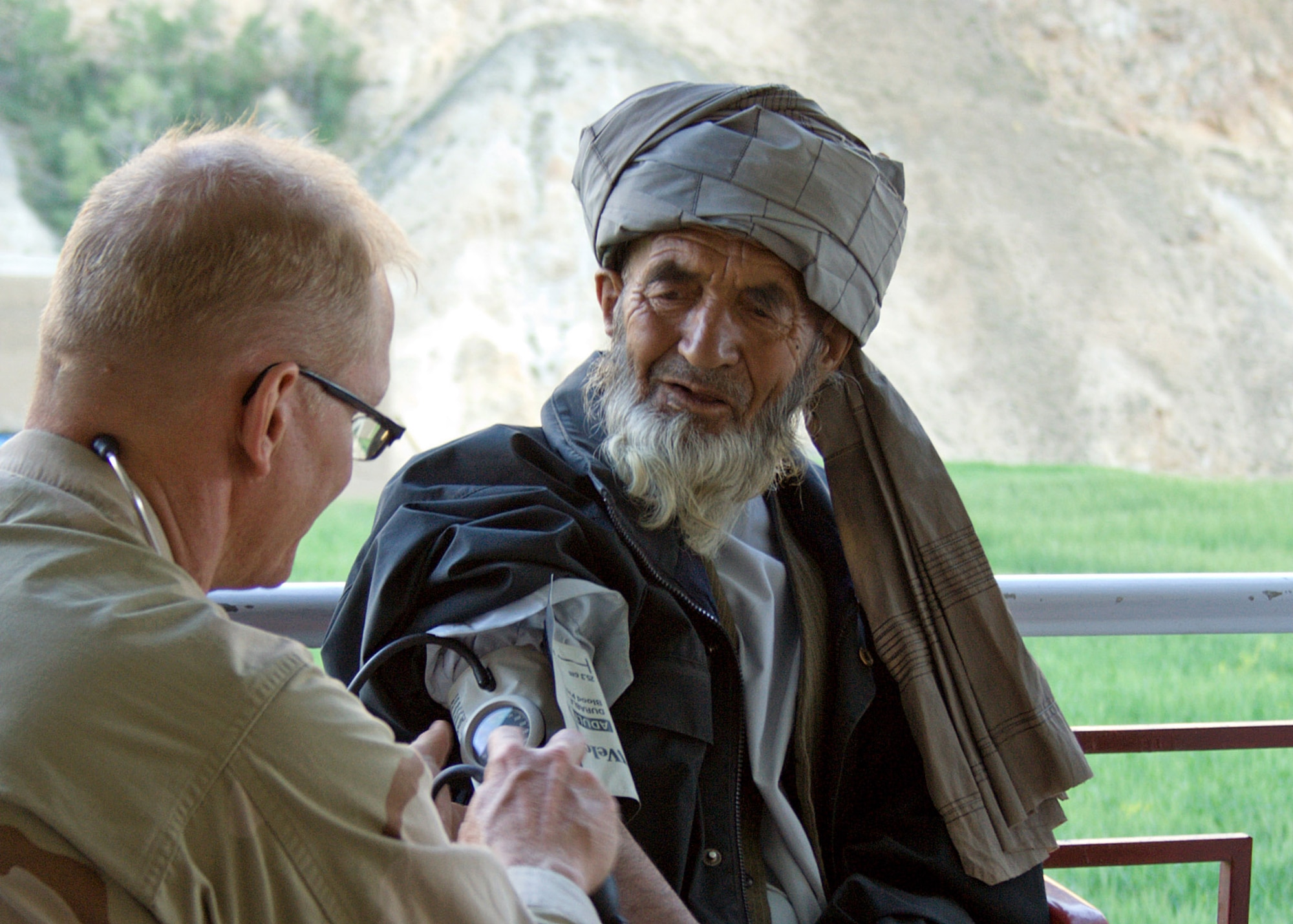 Maj. Kurt Workmaster checks the blood pressure of an elder in the Paryan District on July 16. Three medics from the Panjshir PRT treated more than 200 patients during a Medical Civic Action Program, or MEDCAP, mission that was coordinated by the Panjshir director of health. Major Workmaster is the Panjshir Provincial Reconstruction Team physician assistant. (U.S. Air Force photo/Tech. Sgt. John Cumper)