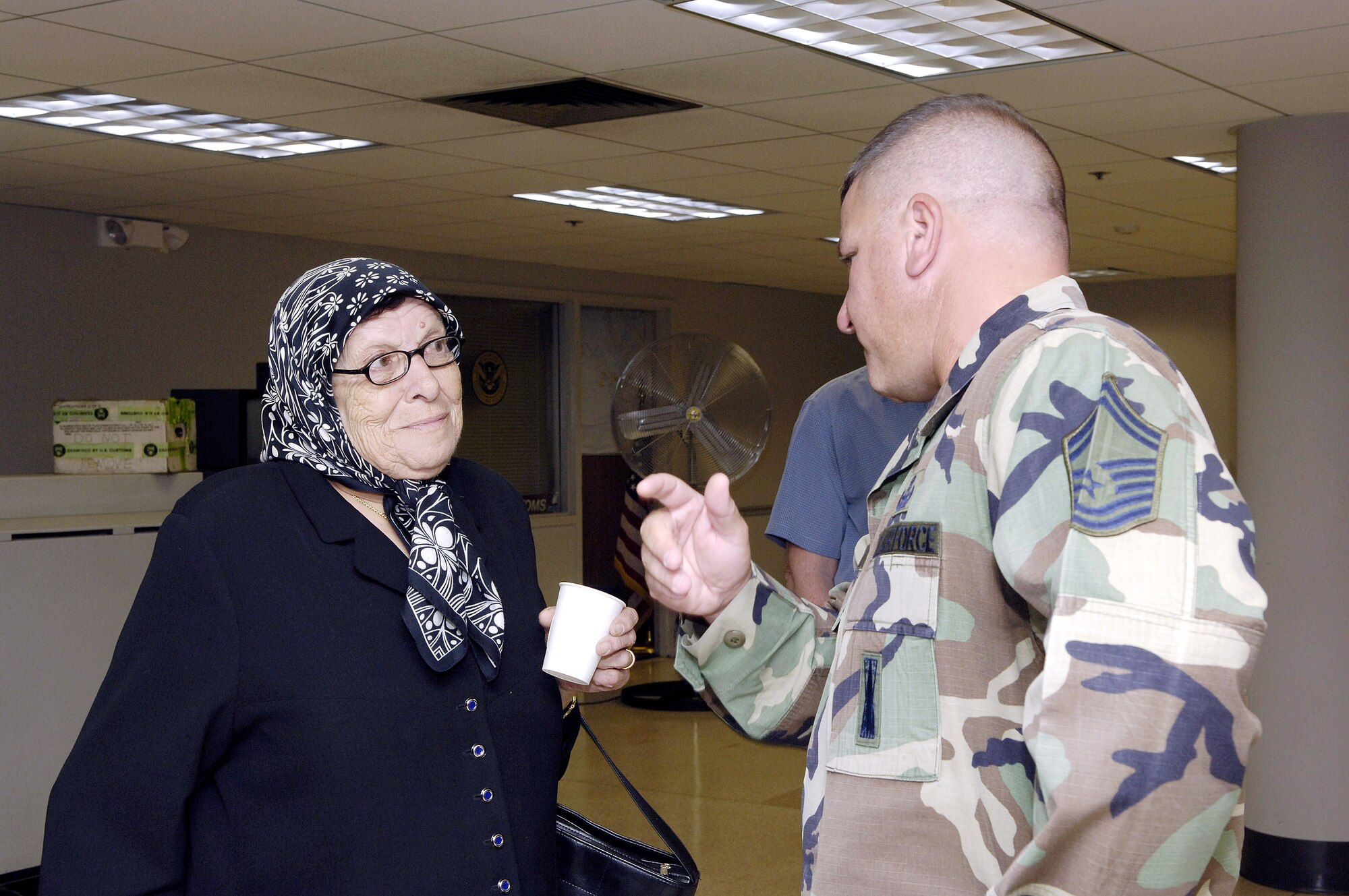 Senior Master Sgt. Muhammad Mustafa translates for Anisheh Bilak, an American citizen from Lebanon, that arrived on Monday, July 24, at McGuire Air Force Base, N.J. McGuire is providing humanitarian assistance for American citizens who are leaving Lebanon to return home after more than a week of fighting between the Israeli military and the militant group Hezbollah. More than an expected 1,000 Americans began arriving at McGuire on July 23. Sergeant Mustafa is assigned to the 305th Civil Engineering Squadron at McGuire. (U.S. Air Force photo/Denise Gould)