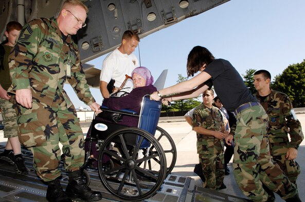 Members from the 305 Air Mobility Wing and New Jersey state police assist an American citizen from Lebanon off a C-17 Globemaster III on Monday, July 24, at McGuire Air Force Base, N.J. McGuire is providing humanitarian assistance for American citizens who are leaving Lebanon to return home after more than a week of fighting between the Israeli military and the militant group Hezbollah. More than an expected 1,000 Americans began arriving at McGuire on July 23. (U.S. Air Force photo/Denise Gould)