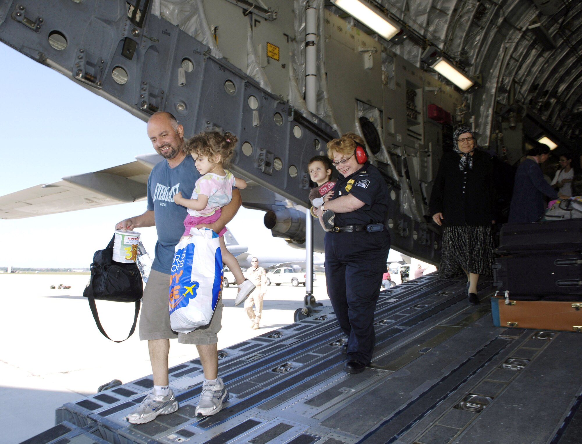 American evacuees from Lebanon depart a C-17 Globemaster III on Monday, July 24, at McGuire Air Force Base, N.J. McGuire is providing humanitarian assistance for American citizens who are leaving Lebanon to return home after more than a week of fighting between the Israeli military and the militant group Hezbollah. More than an expected 1,000 Americans began arriving at McGuire on July 23. (U.S. Air Force photo/Denise Gould)
