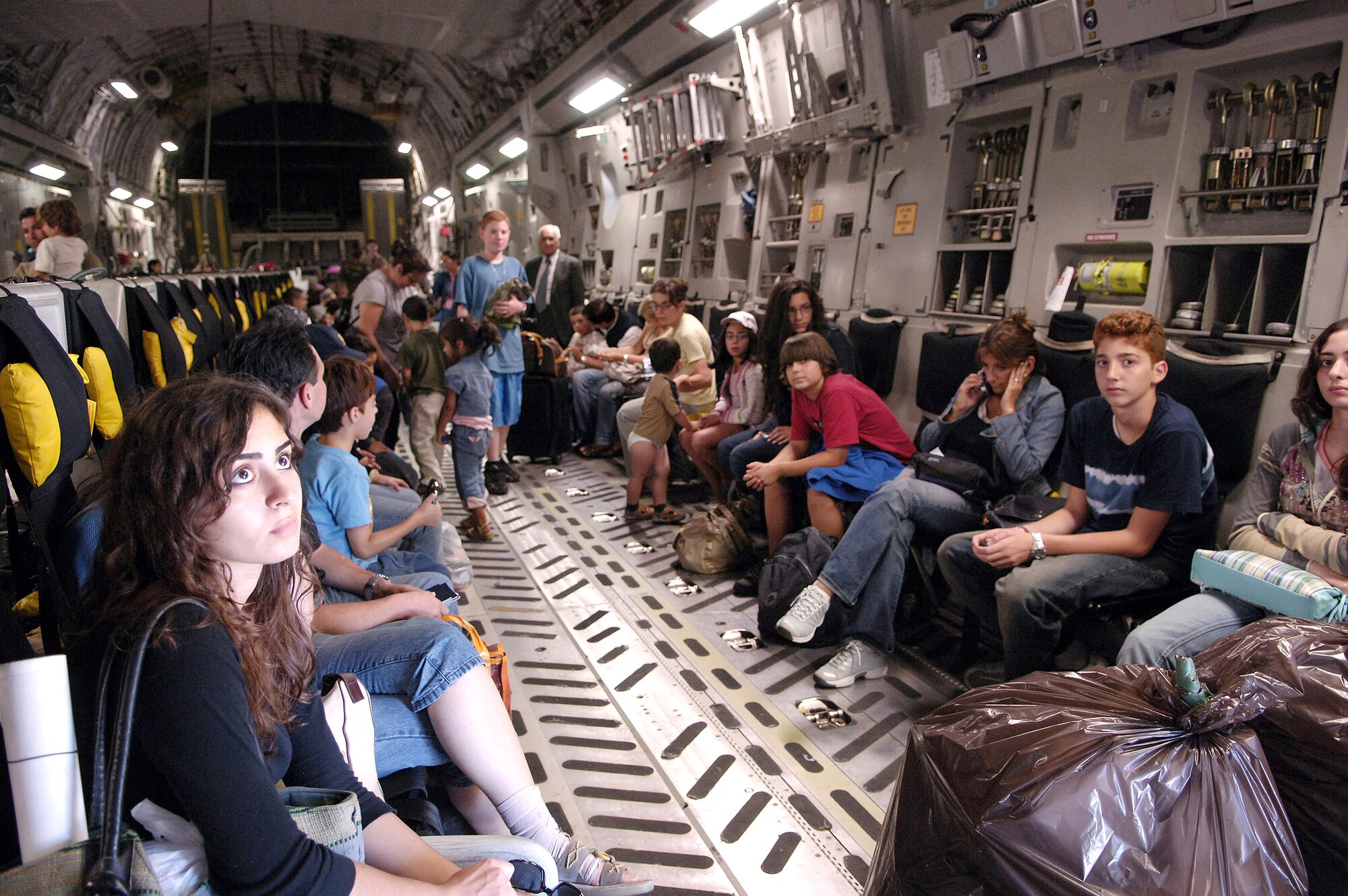 Ninety-five American citizens from Lebanon wait to depart a C-17 Globemaster III on Monday, July 24, at McGuire Air Force Base, N.J. McGuire is providing humanitarian assistance for American citizens who are leaving Lebanon to return home after more than a week of fighting between the Israeli military and the militant group Hezbollah. More than an expected 1,000 Americans began arriving at McGuire on July 23. (U.S. Air Force photo/Denise Gould)
