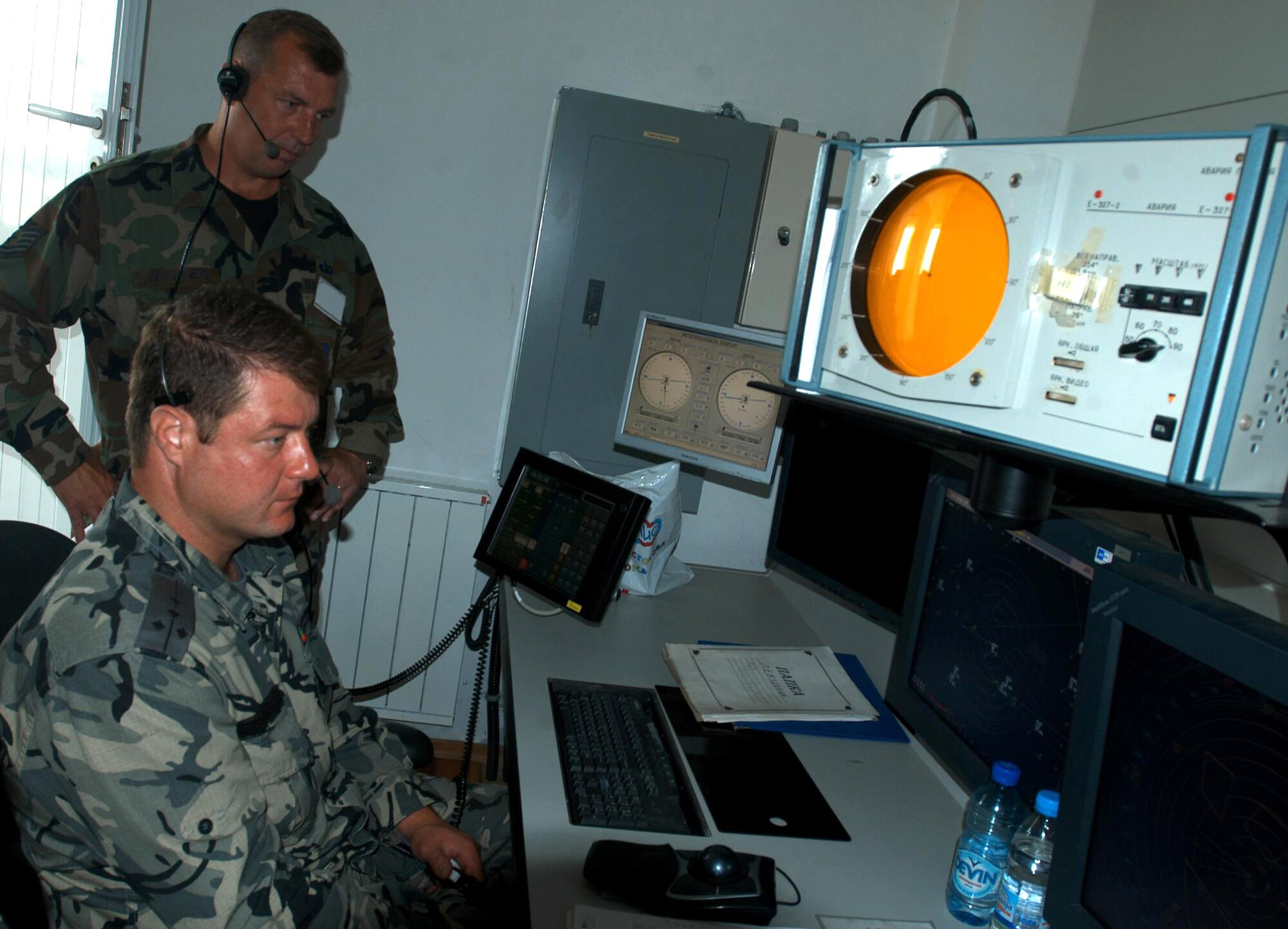 Tech. Sgt. Richard Walker and Capt. Vesselin Aroenski watch the radar as a MiG-29 approaches the runway at Graf Ignatievo Air Base, Bulgaria. The U.S. and Bulgarian military are participating in the exercise Immediate Response 2006. Sergeant Walker is from the 48th Operations Support Squadron at Royal Air Force Lakenheath, England. Captain Aroenski is an approach instructor with the Bulgarian air force. (U.S. Air Force photo/Senior Airman Eric Donner)