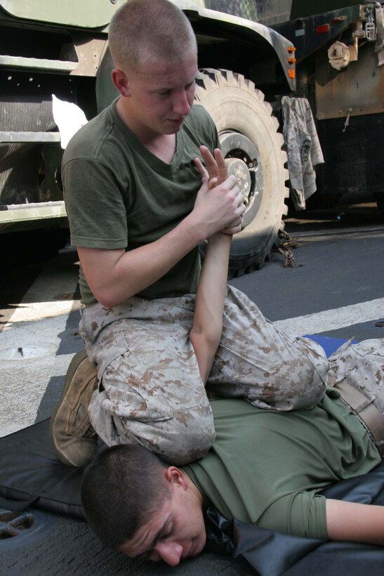 Lance Cpl. Kenneth Geist a native of Glendale, Ariz., and Lance Cpl. Robert Hazelwood, a native of Poquoson, Va., both members of the 24th Marine Expeditionary Unit, conduct Marine Corps Martial Arts aboard the USS Whidbey Island on July 26. Hazelwood and his MCMAP partner are training for their grey belt. (U.S. Marine Corps Photo by Lance Corporal Joshua Lujan)