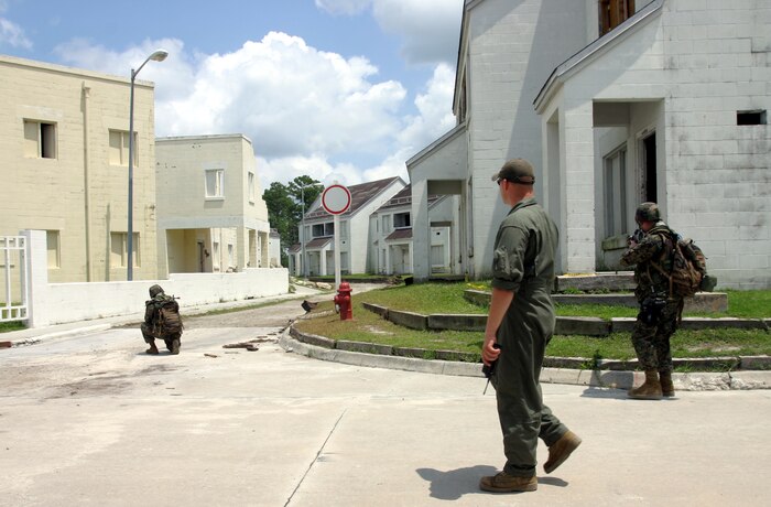 MARINE CORPS BASE CAMP LEJEUNE, N.C. (July 26, 2006) ? A Basic Urban Skills Terrain instructor walks amongst Marines as they practice patrolling through an urban environment here July 26. Marines with Combat Logistics Regiment 27, 2nd Marine Logistics Group learned how to patrol, enter buildings, clear rooms and maintain themselves in an urban environment during a Basic Urban Combat Training course here, July 24 through 28.