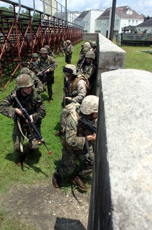 MARINE CORPS BASE CAMP LEJEUNE, N.C. (July 26, 2006) ? Squad by squad, Marines move to another position in an urban training environment here July 26. Marines with Combat Logistics Regiment 27, 2nd Marine Logistics Group learned how to patrol, enter buildings, clear rooms and maintain themselves in an urban environment during a Basic Urban Combat Training course here, July 24 through 28.