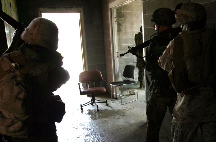 MARINE CORPS BASE CAMP LEJEUNE, N.C. (July 26, 2006) ? Marines prepare to enter and clear a room while training in an urban training environment here July 26. Marines with Combat Logistics Regiment 27, 2nd Marine Logistics Group learned how to patrol, enter buildings, clear rooms and maintain themselves in an urban environment during a Basic Urban Combat Training course here, July 24 through 28. Sleeping, eating and working from sunrise to sunset, the training proved beneficial to the Marines heading to Iraq.