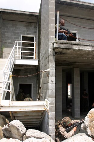 MARINE CORPS BASE CAMP LEJEUNE, N.C. (July 26, 2006) ? A Marine acting as an insurgent sits directly above another Marines during a practical operations training mission here July 26. Marines with Combat Logistics Regiment 27, 2nd Marine Logistics Group learned how to patrol, enter buildings, clear rooms and maintain themselves in an urban environment during a Basic Urban Combat Training course here, July 24 through 28.