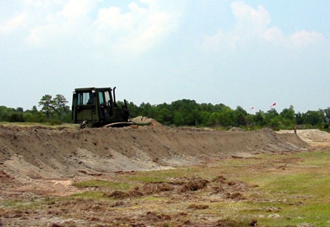 MARINE CORPS RECRUIT DEPOT PARRIS ISLAND, S.C. (July 2006) - Company B, 8th Engineer Support Battalion, 2nd Marine Logistics Group, create a berm at a machinegun range on the depot. More than 3,000 cubic yards of dirt were used in the making of the berm. Three-thousand cubic yards is the equivalent of approximately 330 dump truck loads.