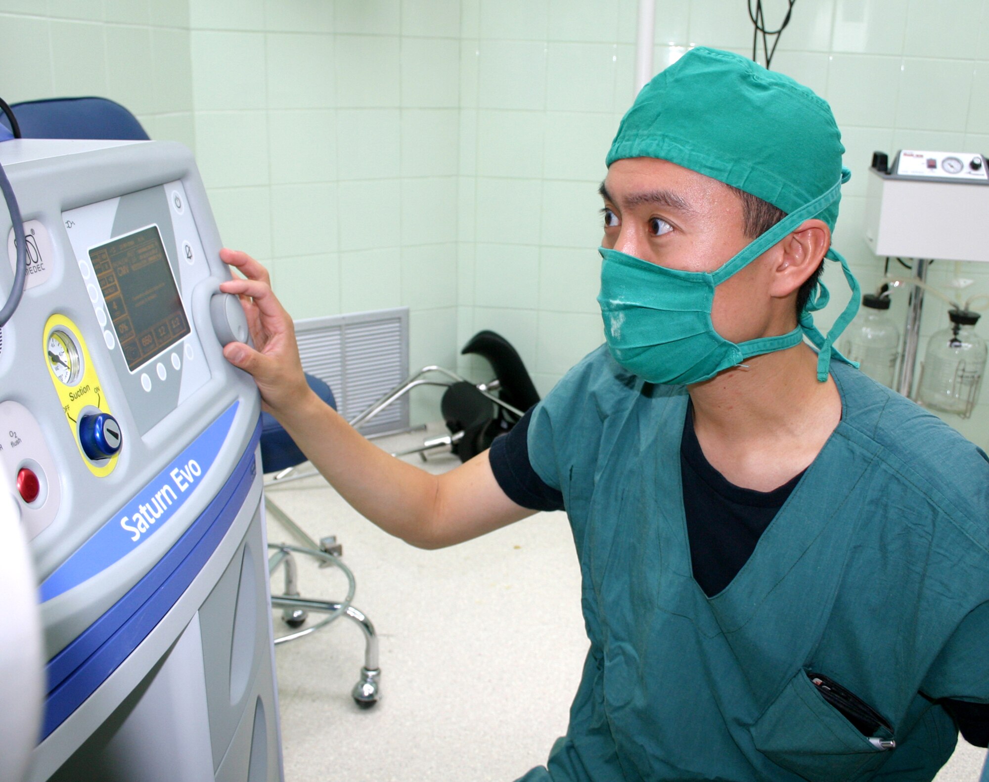 Capt. (Dr.) Jason Lee checks the functionality of an anesthesia machine in Esmereldas, Ecuador. Captain Lee is part of a Medical Readiness Training Exercise team that is performing cleft lip and cleft palate surgery on children of the region. He is an anesthesiologist with the 81st Surgical Operations Squadron at Keesler Air Force Base, Miss.  (U.S. Air Force photo/2nd Lt. David Herndon) 
