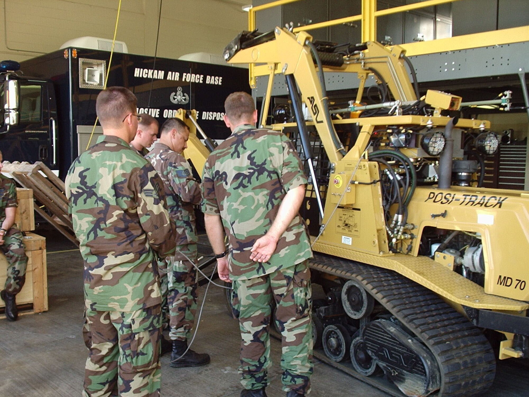 The 944th Civil Engineer Squadron Explosive Ordnance Disposal Flight members add modifications to Hickam Air Force Base's large improvised explosive device robot. The modification kit costs $10,500 and took two days to install. The 944th EOD members provided training for their counterparts at Hickam during their 10-day deployment in Hawaii. (U.S. Air Force courtesy photo)