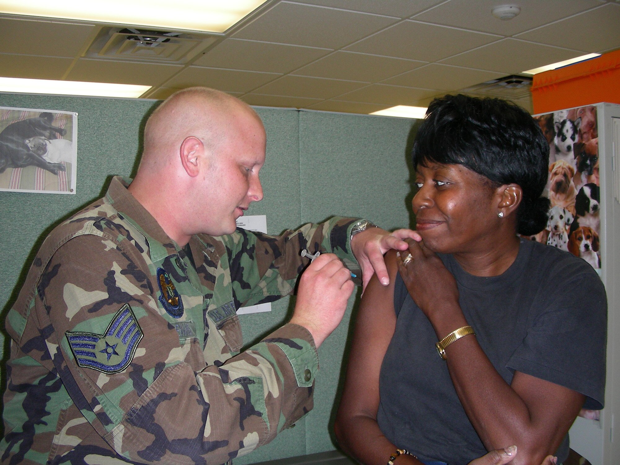 Staff Sgt. Jason Evans administers a vaccination to a 920th Rescue Wing member during the June UTA.  A member of the 920th RQW Aeromedical Staging Squadron, Sergeant Evans faithfully performs his duty during drill weekends despite being diagnosed with stage four Non-Hodgkin's Lymphoma cancer.  The 920th Combat Rescue Top Three recently held a fundraiser in his name.  (U.S. Air Force Photo/2nd Lt. Jaime Pinto.)