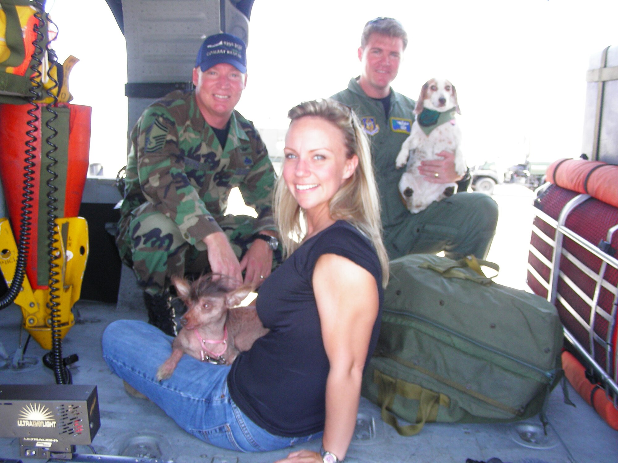 Mrs. Andrea Potts with her dog, Lucille Bald who recently competed in the World's Ugliest Dog Competition and Capt. Mike Brasher with Katrina, a rescue dog from Hurricane Katrina. (U.S. Air Force Photo by 1st Lt. Cathleen Snow)