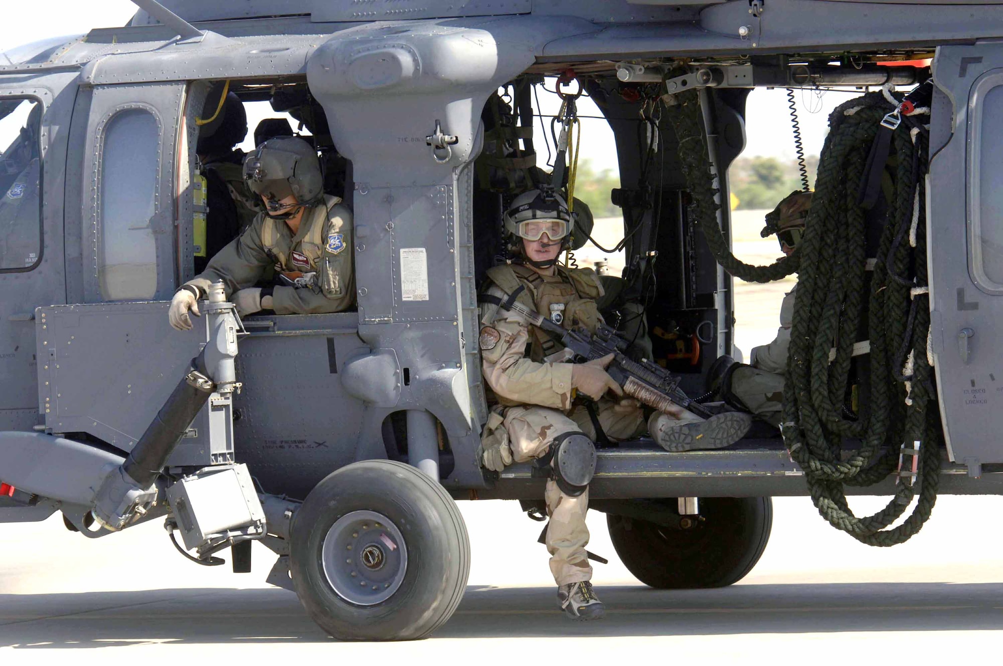 Pararescuemen from the 48th Rescue Squadron sit and await take-off in an HH-60 Pave Hawk from the 305th Rescue Squadron. They were headed to Gila Bend, Ariz., on July 25 for rescue training as part of Exercise Angel Thunder. The five-day exercise, held at Davis-Monthan Air Force Base, Ariz., and other areas is designed to provide realistic combat search and rescue training for active-duty, Reserve and Guard Airmen in combat rescue forces. (U.S. Air Force photo/Senior Airman Christina Ponte) 