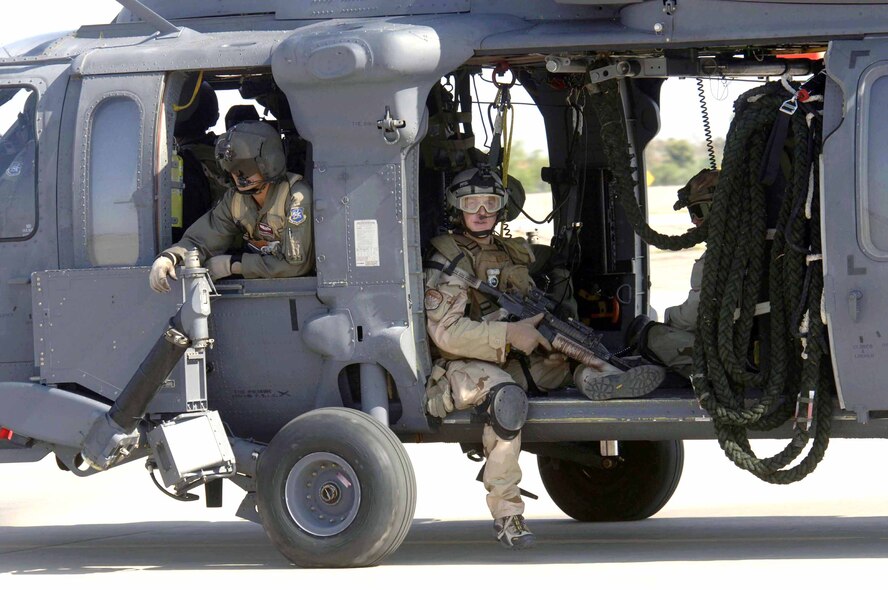 Pararescuemen from the 48th Rescue Squadron sit and await take-off in an HH-60 Pave Hawk from the 305th Rescue Squadron. They were headed to Gila Bend, Ariz., on July 25 for rescue training as part of Exercise Angel Thunder. The five-day exercise, held at Davis-Monthan Air Force Base, Ariz., and other areas is designed to provide realistic combat search and rescue training for active-duty, Reserve and Guard Airmen in combat rescue forces. (U.S. Air Force photo/Senior Airman Christina Ponte) 