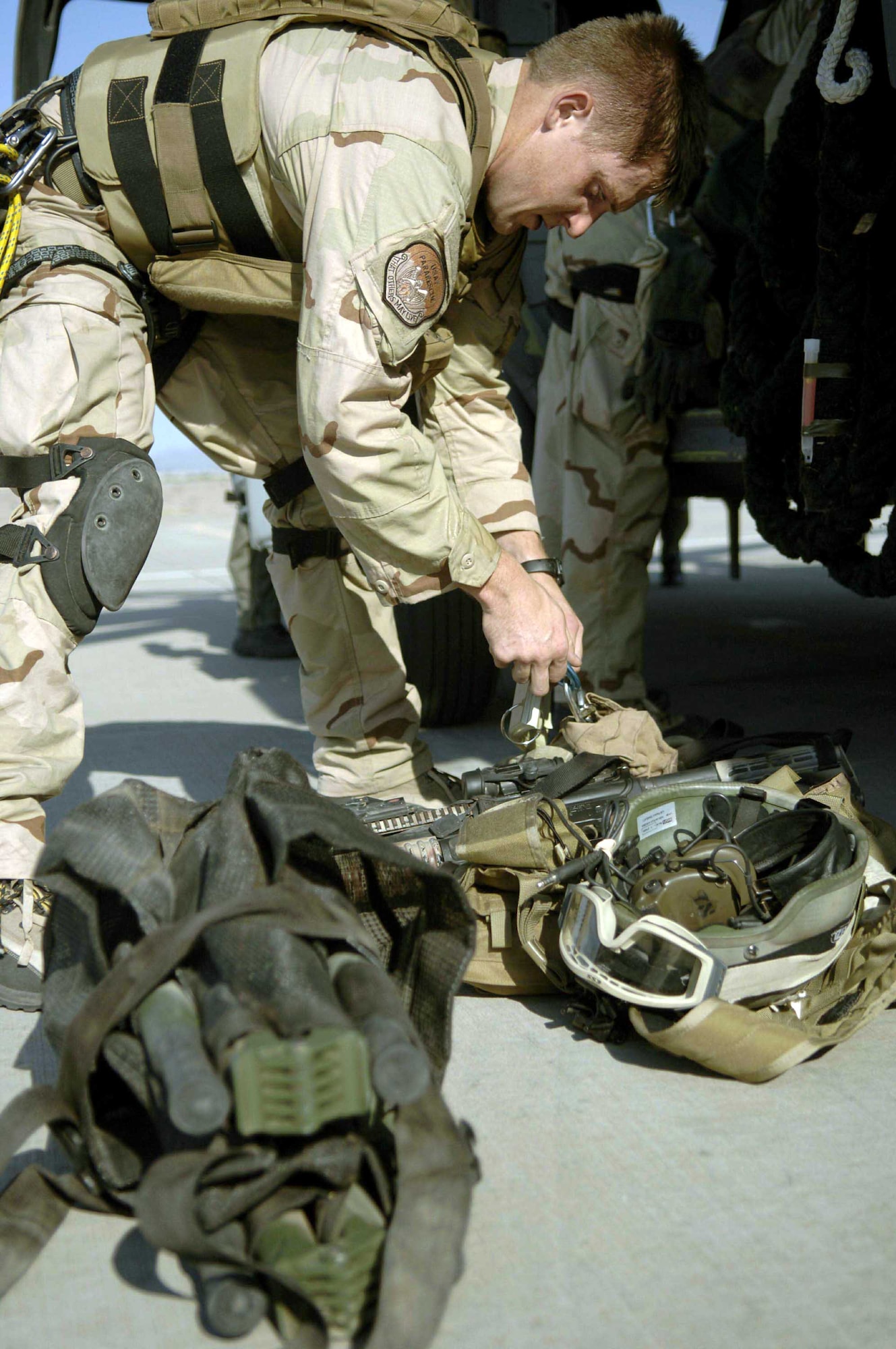 Senior Airman Troy Patrick checks his gear as he prepares to fly to Gila Bend, Ariz., for Exercise Angel Thunder on July 25. The five-day exercise, held at Davis-Monthan Air Force Base, Ariz., and other areas is designed to provide realistic combat search and rescue training for active-duty, Reserve and Guard Airmen in combat rescue forces. Airman Patrick is a pararescueman with the 48th Rescue Squadron. (U.S. Air Force photo/Senior Airman Christina Ponte)