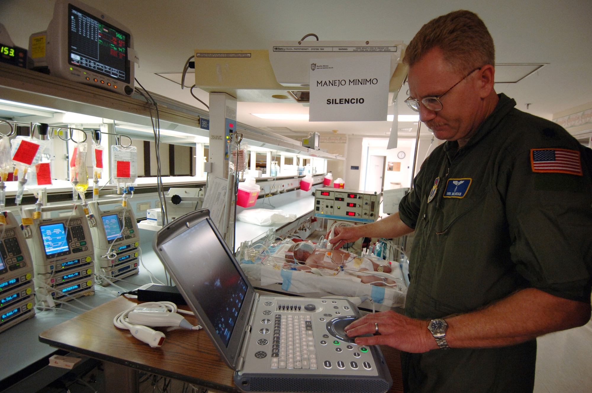 Lt. Col. Kirk Milhoan a Pediatric Cardiologist checks the heart function of 3-day-old Stuart Parker prior to being placed on a transportable Extracorporeal Membrane Oxygenation unit on July 21 in San Juan, Puerto Rico. An ECMO team comprised Air Force and Army medical specialists from the Wilford Hall Medical Center at Lackland Air Force Base, Texas, flew to Puerto Rico to transport Stuart to San Antonio for more advanced care. (U.S. Air Force photo/Master Sgt. Scott Reed)