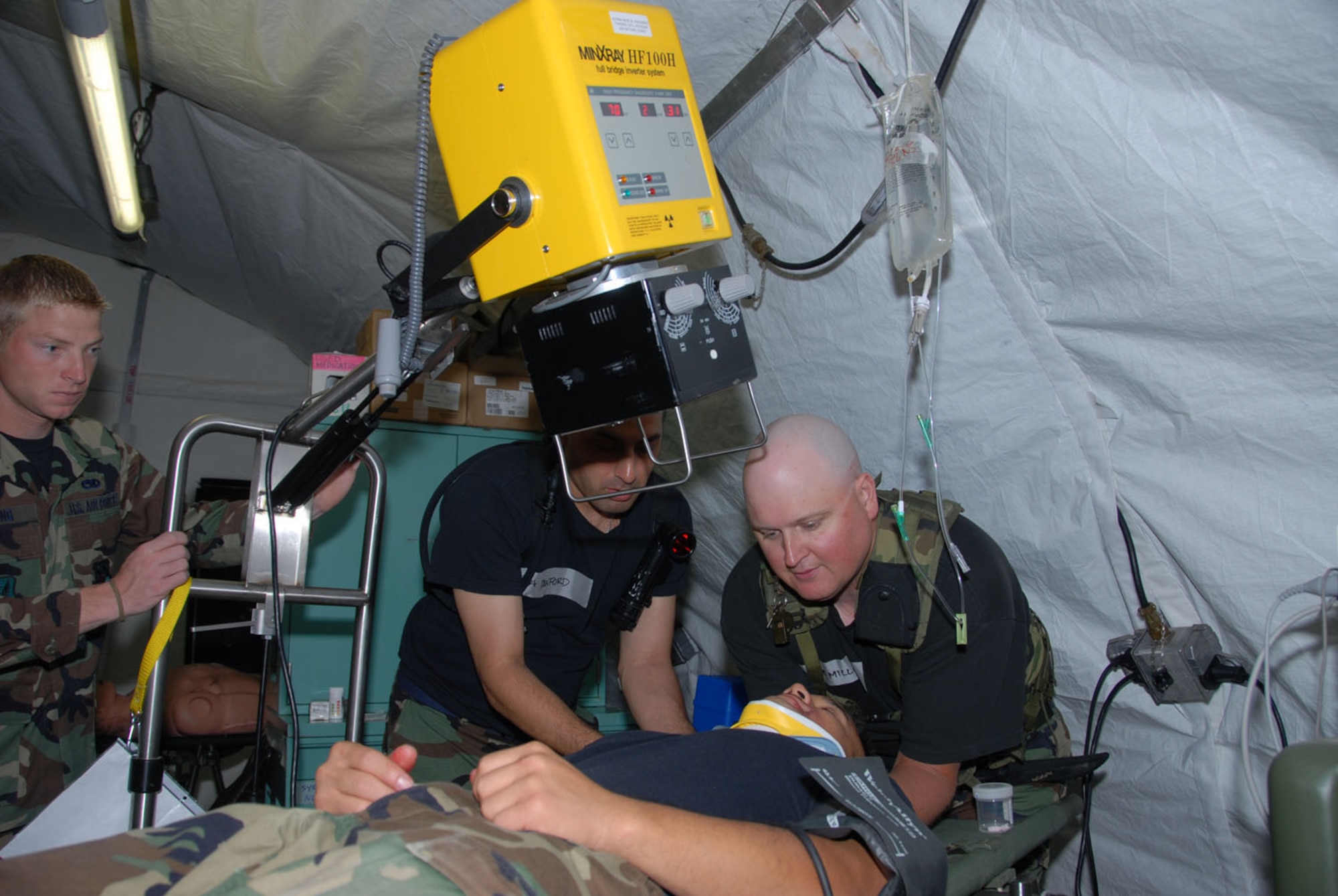 Senior Airman James Young (left), 442nd Medical Squadron, Whiteman Air Force Base, Mo.; Senior Airman Richard Danford (center), 138th Medical Group, Oklahoma Air National Guard; and Tech. Sgt. Christopher E. Miller, 442nd MDS, perform an X-ray during Expeditionary Medical Support System training at Fort McCoy, Wis., as part of Patriot 06. (U.S. Air Force photo/Master Sgt. Chance Babin)