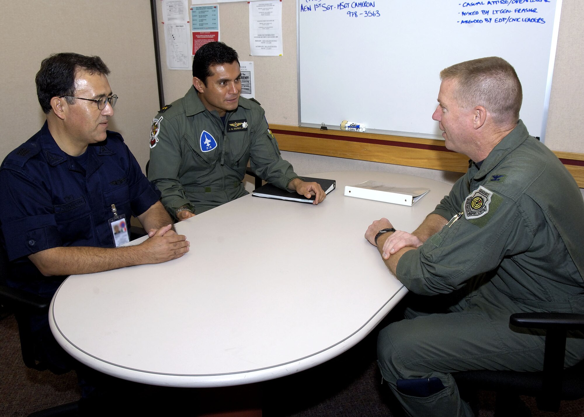EIELSON AIR FORCE BASE, Alaska - Lieutenant Colonel Jose Antonio Sierra Amador and Captain Gerard de Jesus Navarro Mannon,the Mexican Air Force observers, speak with Colonel Rusty Cabot, Excersise Cooperative Cope Thunder 06-3 (CCT06-3) deployed forces commander. The Mexican Air Force is looking to participate in an exercise like sometime in the future.  Photo by Cpl J.A. Wilson, CCT06-3 Canadian Public Affairs