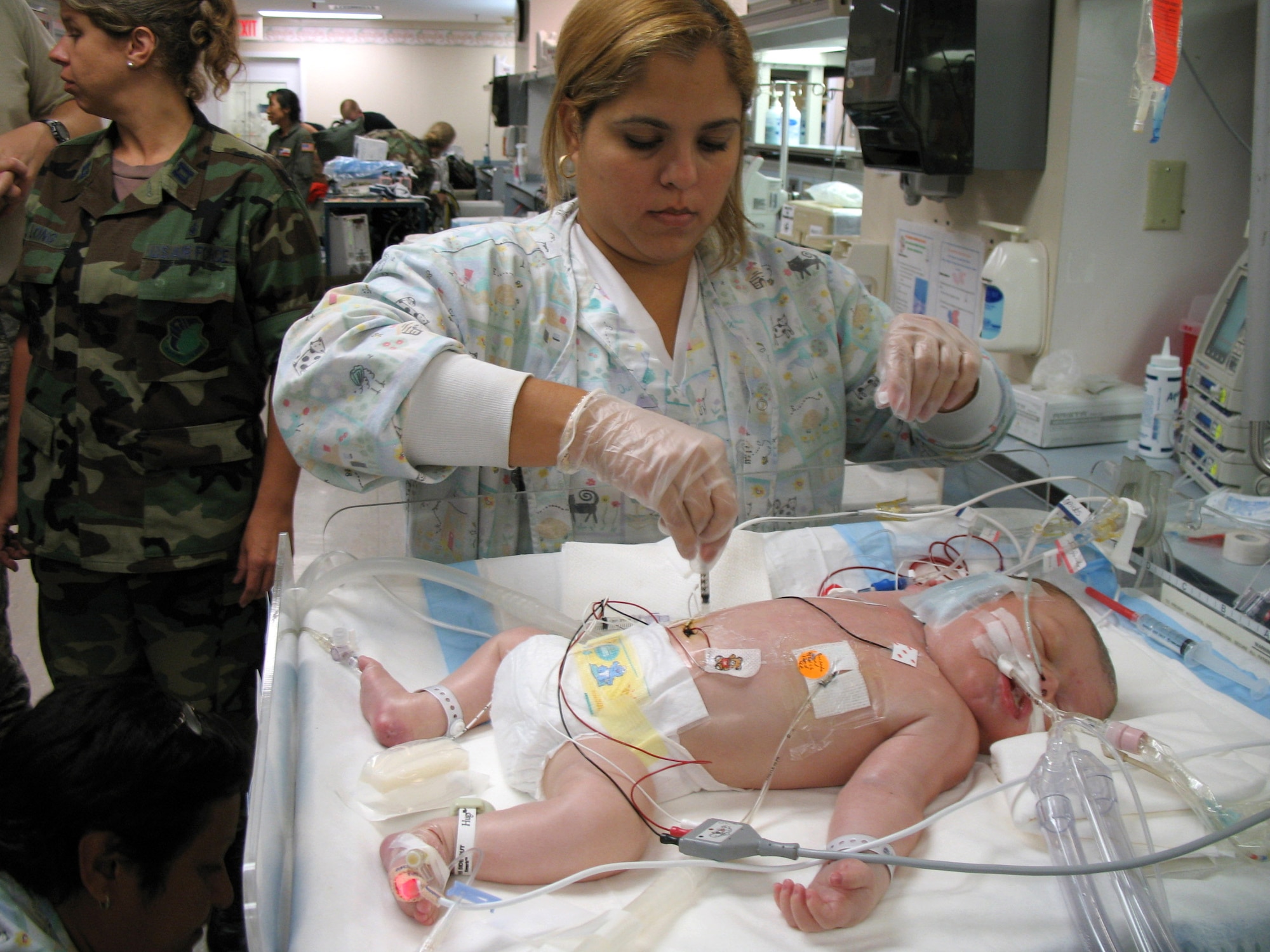 Michelle Sirra takes a blood sample from 3-day-old Stuart Parker in preparation for transfer to an Extracorporeal Membrane Oxygenation unit on Friday, July 21, in San Juan, Puerto Rico. An ECMO team comprised Air Force and Army medical specialists from the Wilford Hall Medical Center at Lackland Air Force Base, Texas, flew to Puerto Rico to transport Stuart to San Antonio for more advanced care. Ms. Sirra is a respiratory therapist in the neonatal intensive care unit at the Hospital Auxilio Mutuo in San Juan. (U.S. Air Force photo/Staff Sgt. Matthew Rosine) 