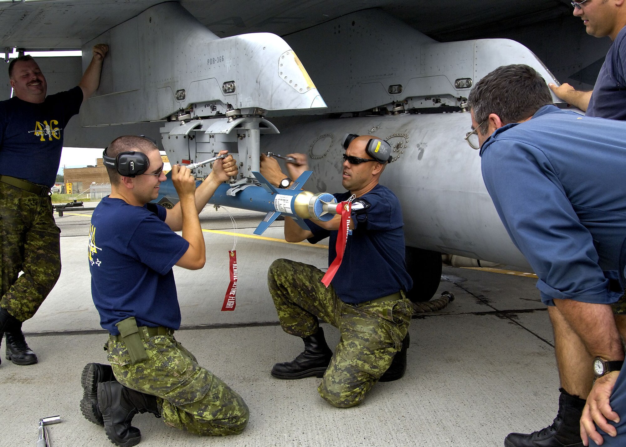 EIELSON AIR FORCE BASE, Alaska - A 409 Tactical Fighter Squadron armarmanet load crew loads a Laser Guided Training Round on a CF-18 during Excersise Cooperative Cope Thunder 06-3 (CCT06-3). CCT06-3 is an annually run excersise with missions being flown out of both Eielson and Elmendorf Air Force Base (AFB), Alaska from Jul 20 - Aug 5 2006. Excersise participants this year include Canada the United States, Japan, Sweden, Nato, Mongolia, South Korea, Germany, the Slovak Republic, and Australia. Observer nations include Mexico, Bangladesh, Sri Lanka Malaysia, and Russia. Approximately 1300 service personnel are participating, about 800 of those from the host nation. Photo by Cpl J.A. Wilson, CCT06-3 Canadian Public Affairs