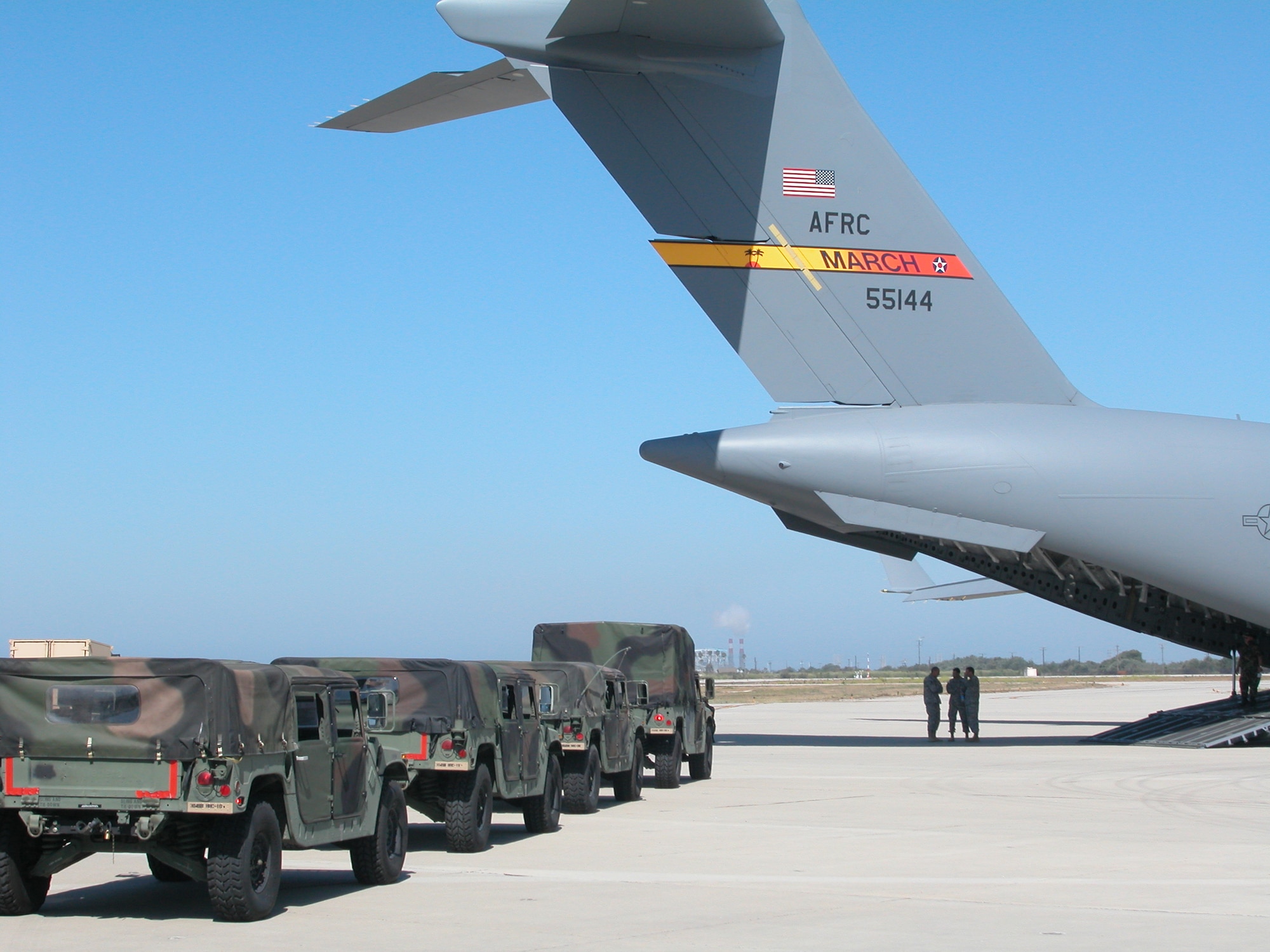 MARCH AIR RESERVE BASE, Calif. -- Vehicles from the Army Reserve's 304th Sustainment Brigade, based in West Los Angeles, line up to be loaded onto an Air Force Reserve Command C-17 from the 452nd Air Mobility Wing from here July 15, 2006.  Since the brigade was relocating to March ARB anyway, the Soldiers and Airmen of the respective units used the move to train in responding to a simulated disaster. (U.S. Air Force photo/Staff Sgt. Joe Davidson)
