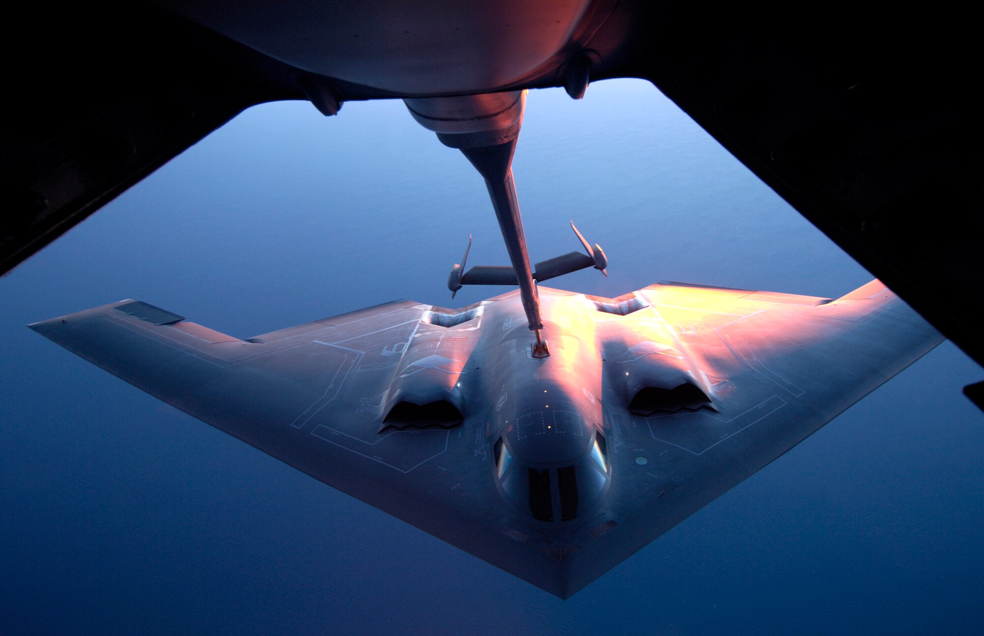 A B-2 Spirit is refueled by a KC-10 Extender over Australia during exercise Green Lightning on Tuesday, July 25. The KC-10 and B-2 are from the 36th Expeditionary Wing at Guam. The exercise will test U.S. capabilities and provide operational familiarity in the region for the Pacific bomber presence as well as serve to enhance relations with the Australians. (U.S. Air Force photo/ Tech. Sgt. Shane A. Cuomo)