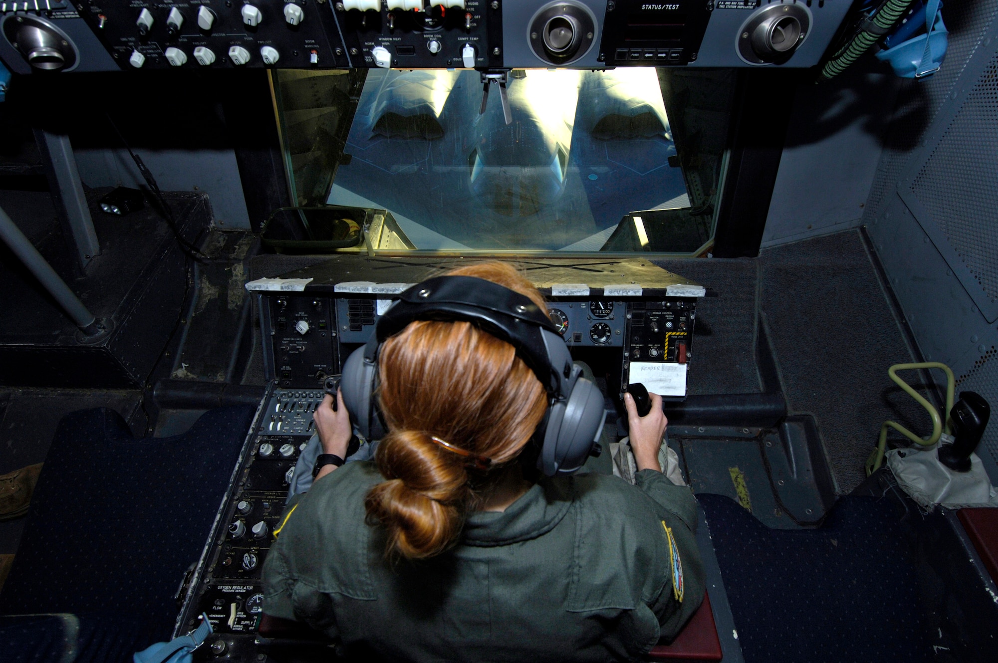 Senior Airman Alicia Trudeau refuels a B-2 Spirit from a KC-10 Extender over Australia during exercise Green Lightning on Tuesday, July 25. The KC-10 and B-2 are from the 36th Expeditionary Wing at Guam. The exercise will test U.S. capabilities and provide operational familiarity in the region for the Pacific bomber presence as well as serve to enhance relations with the Australians. Airman Trudeau is deployed from the 78th Air Refueling Squadron at McGuire Air Force Base, N.J. (U.S. Air Force photo/ Tech. Sgt. Shane A. Cuomo)