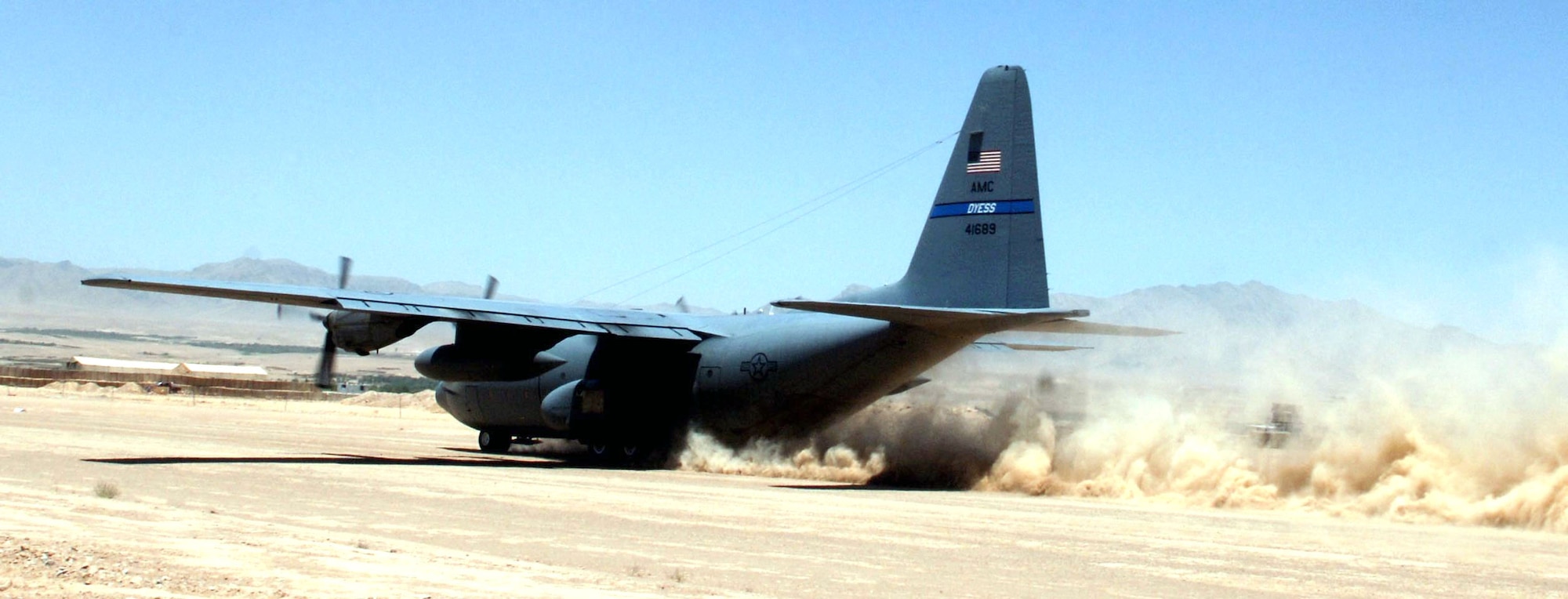 A 455th Air Expeditionary Wing C-130 Hercules touches down on Tarin Kowt's dirt runway. Because of the increased threat level there, aircrews make the stop there as brief as possible. (U.S. Air Force photo/Master Sgt. Orville F. Desjarlais Jr.) 

