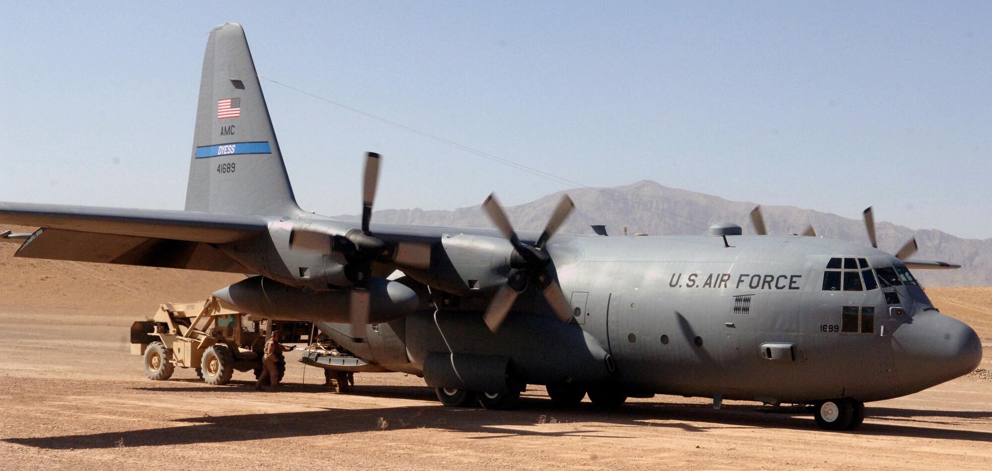 Tech. Sgt. Philip Lester hurridly unloads a 455th Air Expeditionary Wing C-130 Hercules on Tarin Kowt?s dirt runway. In 114-degree temperatures and prop wash from the Herc, the temperatures behind the plane reach to about 140 degrees.