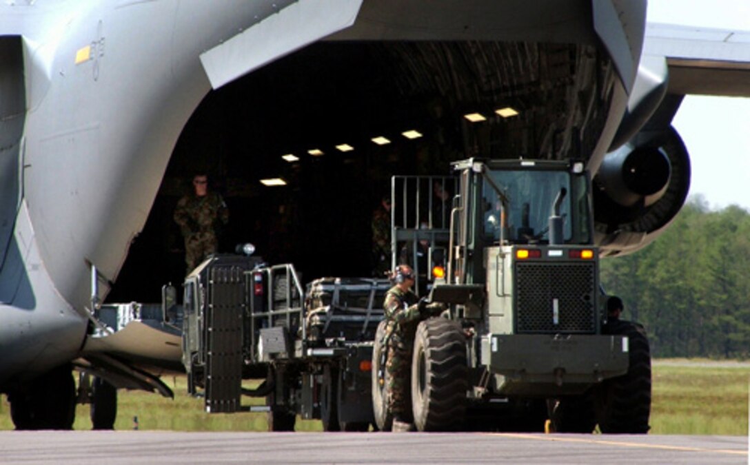 U.S. Air Force airmen unload cargo from a C-17 Globemaster III aircraft from McGuire Air Force Base, N.J., during exercise Eagle Flag 06-3 at Naval Air Engineering Station Lakehurst, N.J., July 17, 2006. 