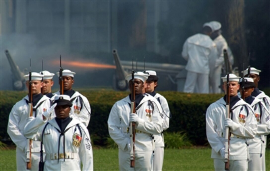 The Navy Ceremonial Guard stands at attention while the ceremonial battery cannon fires 19 rounds in honor of the official party for the change of charge ceremony for the office of the Master Chief Petty Officer of the Navy in Washington, D.C., July 10, 2006.
