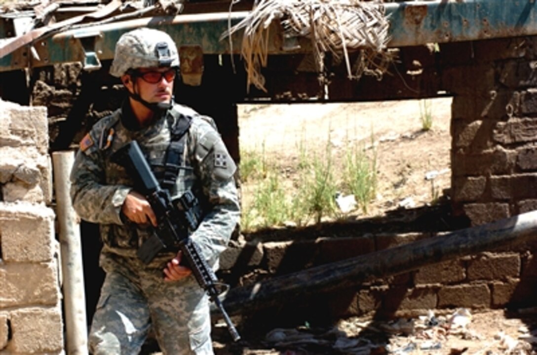 A U.S. Army soldier from 506th Regimental Combat Team, 101st Airborne Division, searches abandoned buildings and homes while on patrol along the Diyala River in East Baghdad, Iraq, July 4, 2006. 