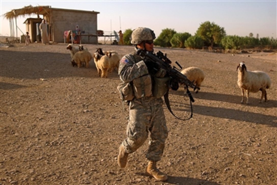 U.S. Army Pfc. Andy Dorau walks to the next house to be searched during a cordon knock patrol July 10, 2006, in Mosul, Iraq. Dorau is assigned to 4th Platoon, Charlie Company, 2nd Battalion, 1st Infantry Regiment, 172nd Stryker Brigade Combat Team based out of Fort Wainwright, Alaska.