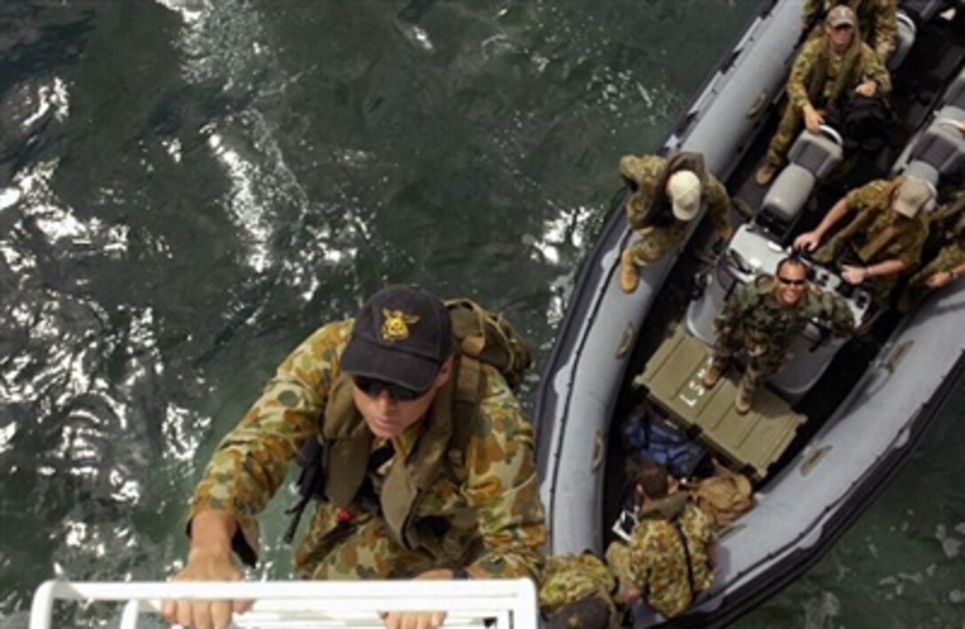 Leading Seaman Ben Abbott, assigned to Australian Clearance Diving Team 1, boards the guided-missile cruiser USS Valley Forge, during a Vehicle Board Search and Seizure exercise as part of Exercise Rim of the Pacific, July 10, 2006. Eight nations participate in RIMPAC, the world's largest biennial maritime exercise off the coast of Hawaii. 