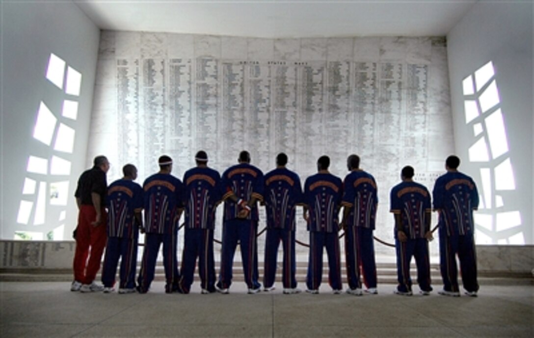 Members of the Harlem Globetrotters 2006 team view the names of sailors and Marines killed during the attack on Pearl Harbor at the USS Arizona Memorial during a visit to Naval Station Pearl Harbor, Hawaii, July 13, 2006. Since playing their first game in 1927, the Harlem Globetrotters have traveled worldwide entertaining basketball fans. The team will perform an exhibition basketball game and provide a youth basketball camp for military and Department of Defense children. 