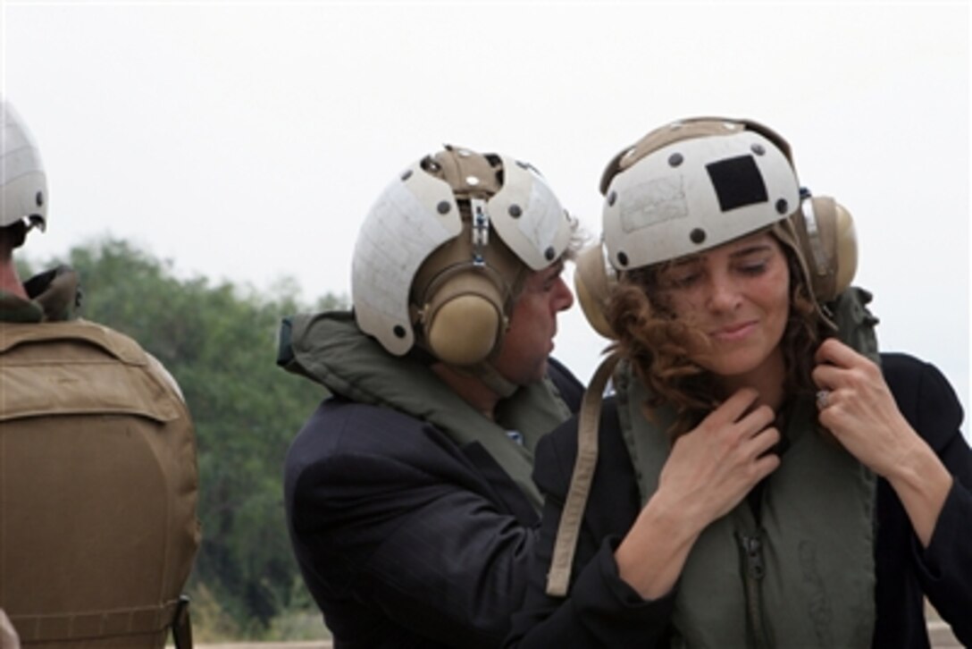 A U.S. citizen dons an air crew cranial and ear protection before boarding a U.S. Marine Corps CH-53E Super Stallion helicopter, assigned to the "Blue Knights" of Marine Medium Helicopter Squadron 365, in Beirut, Lebanon, July 18, 2006. At the request of the U.S. Ambassador to Lebanon and at the direction of the U.S. Defense Secretary, the United States Central Command and the 24th Marine Expeditionary Unit are assisting with the departure of U.S. citizens from Lebanon. 