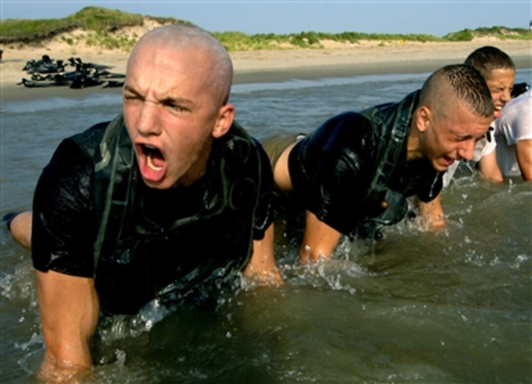 U.S. Naval sea cadets do pushups on the coastline of Fort Story in Virginia Beach, Va., during explosive ordnance disposal and dive training, July 12, 2006. The three-week long course not only educates sea cadets about the naval special warfare community, but also emphasizes the importance of teamwork. 