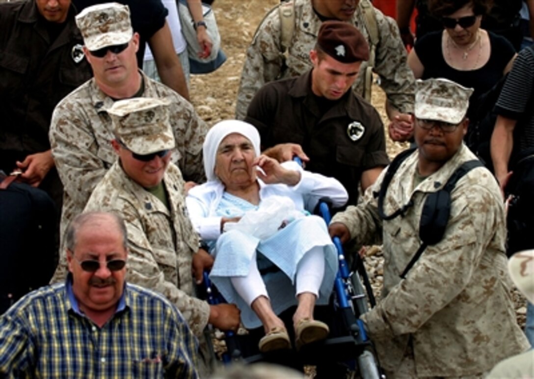 U.S. Marines assigned to the 24th Marine Expeditionary Unit embarked aboard the amphibious transport dock USS Nashville transport a U.S. citizen in Beruit, Lebanon, onto a Landing Craft Utility for transport to the ship, July 20, 2006. 